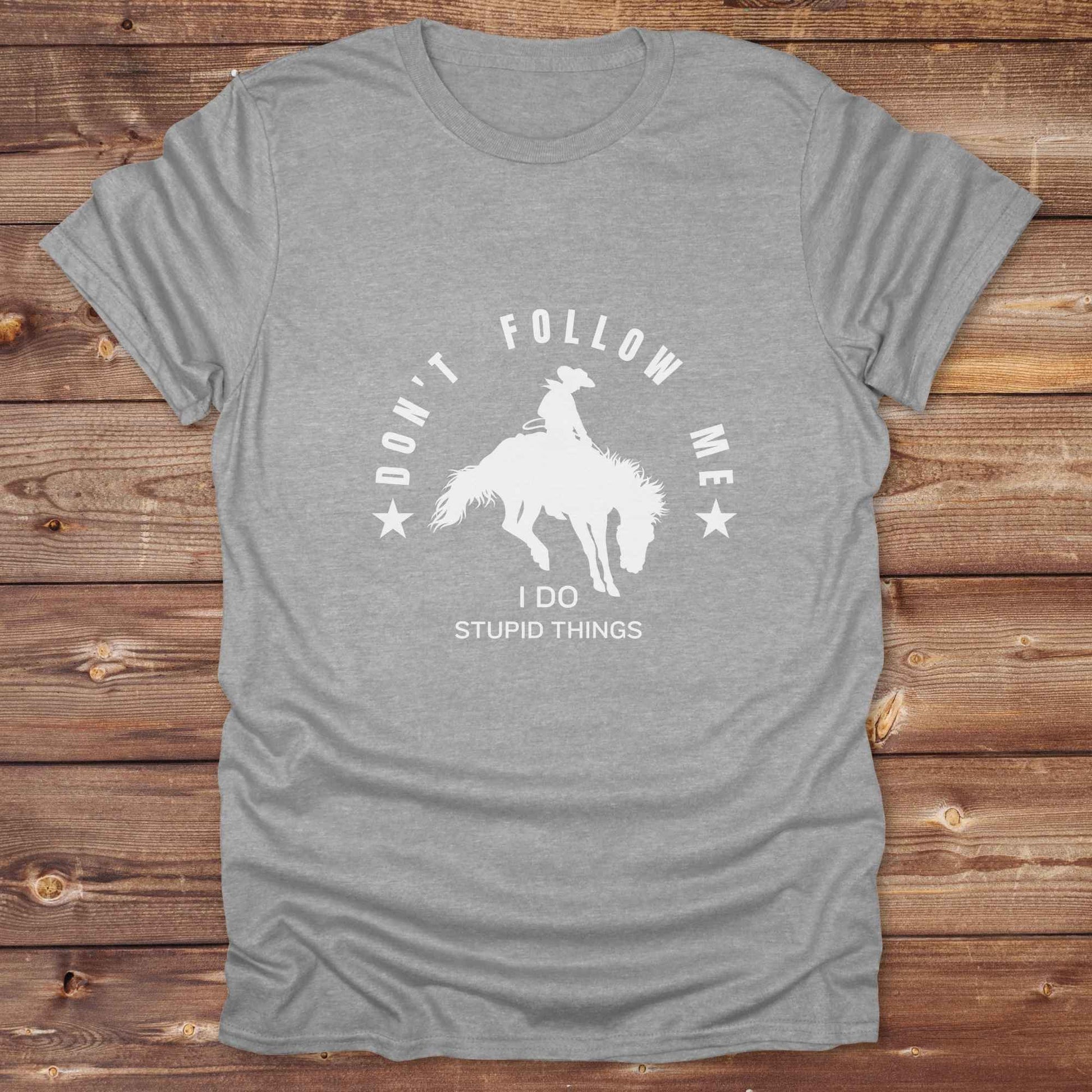 Fun western t-shirt for horse lovers and cowgirls. Western cowgirl graphic tee with horse design. Cowboy humor t-shirt for rodeo and country lovers. Horse lover funny t-shirt with western theme. Country style horse graphic tee for cowboys and cowgirls. Retro style funny western shirt for equestrians. Cute and funny country shirt with horse print. Southern cowgirl funny quote shirt for horse lovers. Dont follow me I do stupid things.