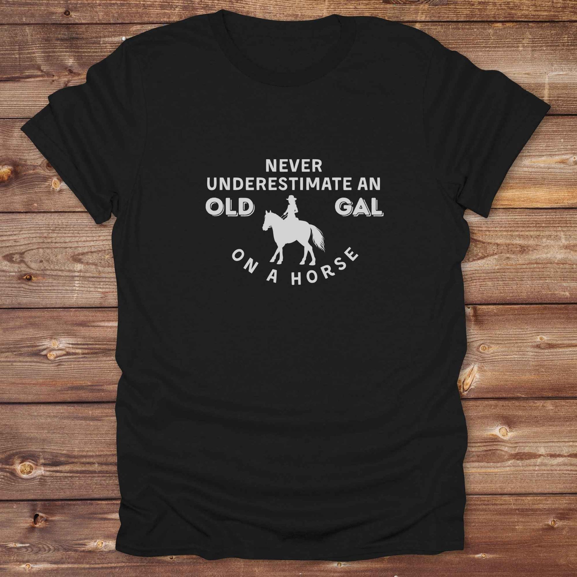 Fun western t-shirt for horse lovers and cowgirls. Western cowgirl graphic tee with horse design. Cowboy humor t-shirt for rodeo and country lovers. Horse lover funny t-shirt with western theme. Country style horse graphic tee for cowboys and cowgirls. Retro style funny western shirt for equestrians. Cute and funny country shirt with horse print. Southern cowgirl funny quote shirt for horse lovers. Never underestimate an old gal on a horse.