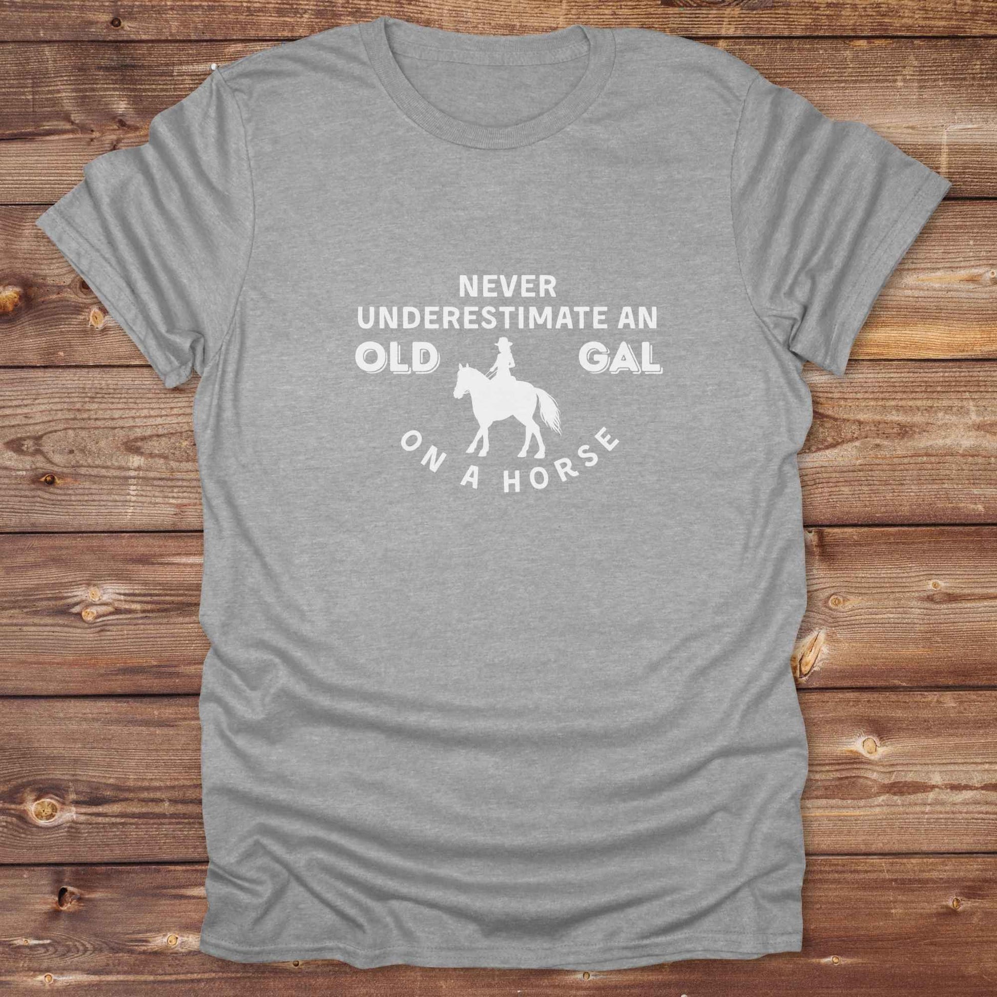 Fun western t-shirt for horse lovers and cowgirls. Western cowgirl graphic tee with horse design. Cowboy humor t-shirt for rodeo and country lovers. Horse lover funny t-shirt with western theme. Country style horse graphic tee for cowboys and cowgirls. Retro style funny western shirt for equestrians. Cute and funny country shirt with horse print. Southern cowgirl funny quote shirt for horse lovers. Never underestimate an old gal on a horse.