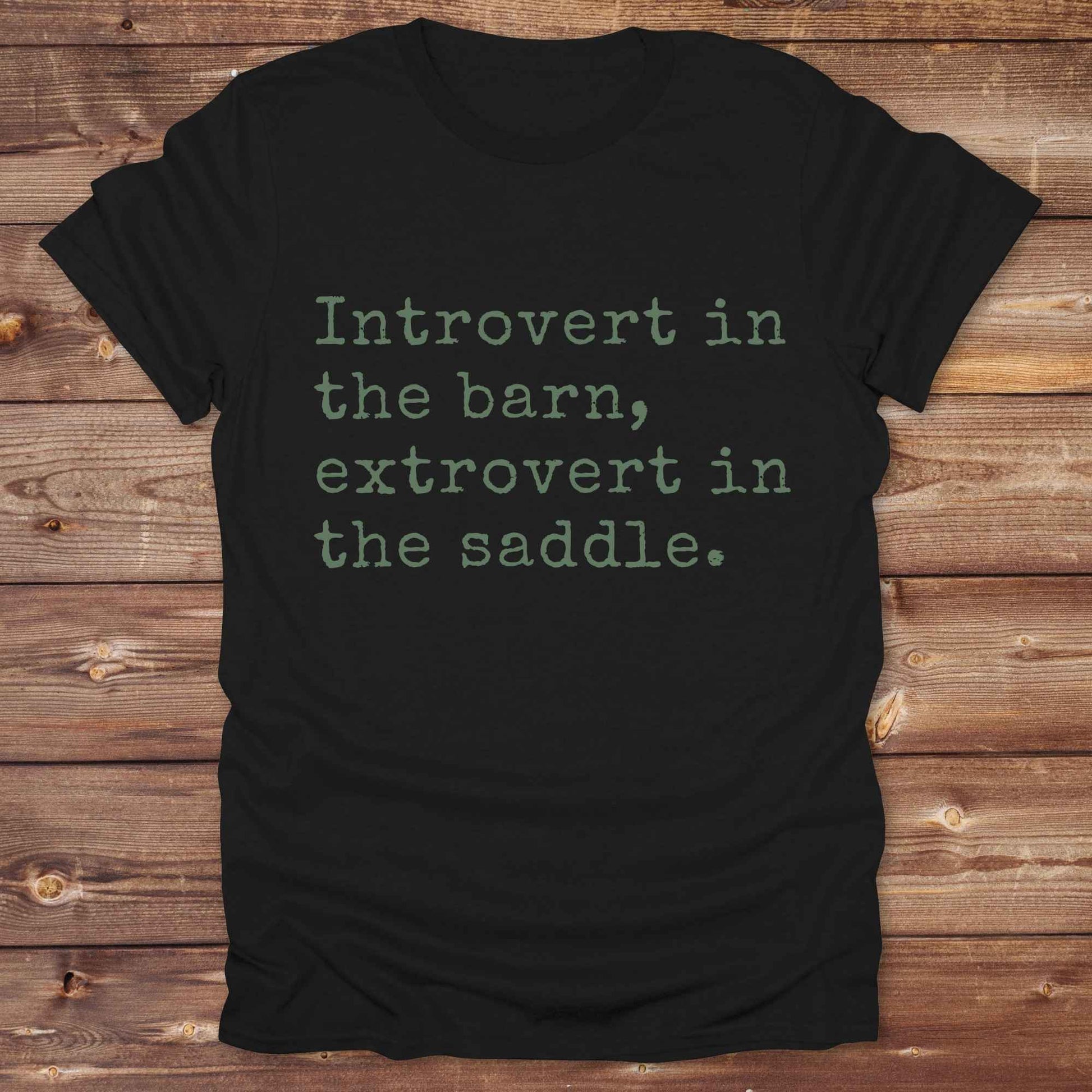 “Introvert in the Barn, Extrovert in the Saddle” t-shirt is the ultimate tee for horse lovers, cowgirls, and western introverts. Whether you're quietly mucking stalls or stealing the show in the arena. made for equestrian souls who ride louder than they talk. Designed with comfort in mind, this western quote shirt is perfect for rodeo nights, barn hangs, or gifting a fellow horse girl.