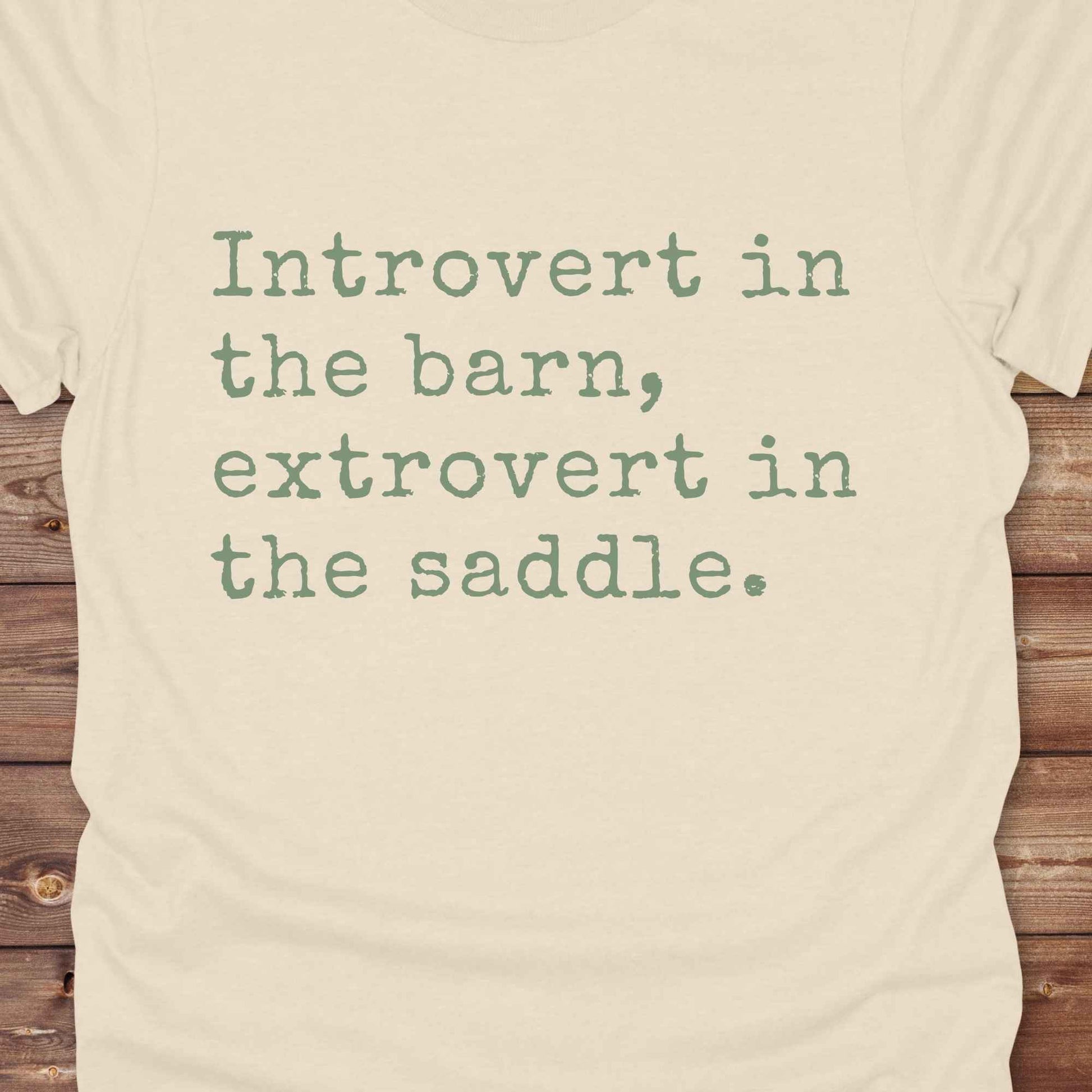 “Introvert in the Barn, Extrovert in the Saddle” t-shirt is the ultimate tee for horse lovers, cowgirls, and western introverts. Whether you're quietly mucking stalls or stealing the show in the arena. made for equestrian souls who ride louder than they talk. Designed with comfort in mind, this western quote shirt is perfect for rodeo nights, barn hangs, or gifting a fellow horse girl.