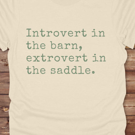 “Introvert in the Barn, Extrovert in the Saddle” t-shirt is the ultimate tee for horse lovers, cowgirls, and western introverts. Whether you're quietly mucking stalls or stealing the show in the arena. made for equestrian souls who ride louder than they talk. Designed with comfort in mind, this western quote shirt is perfect for rodeo nights, barn hangs, or gifting a fellow horse girl.