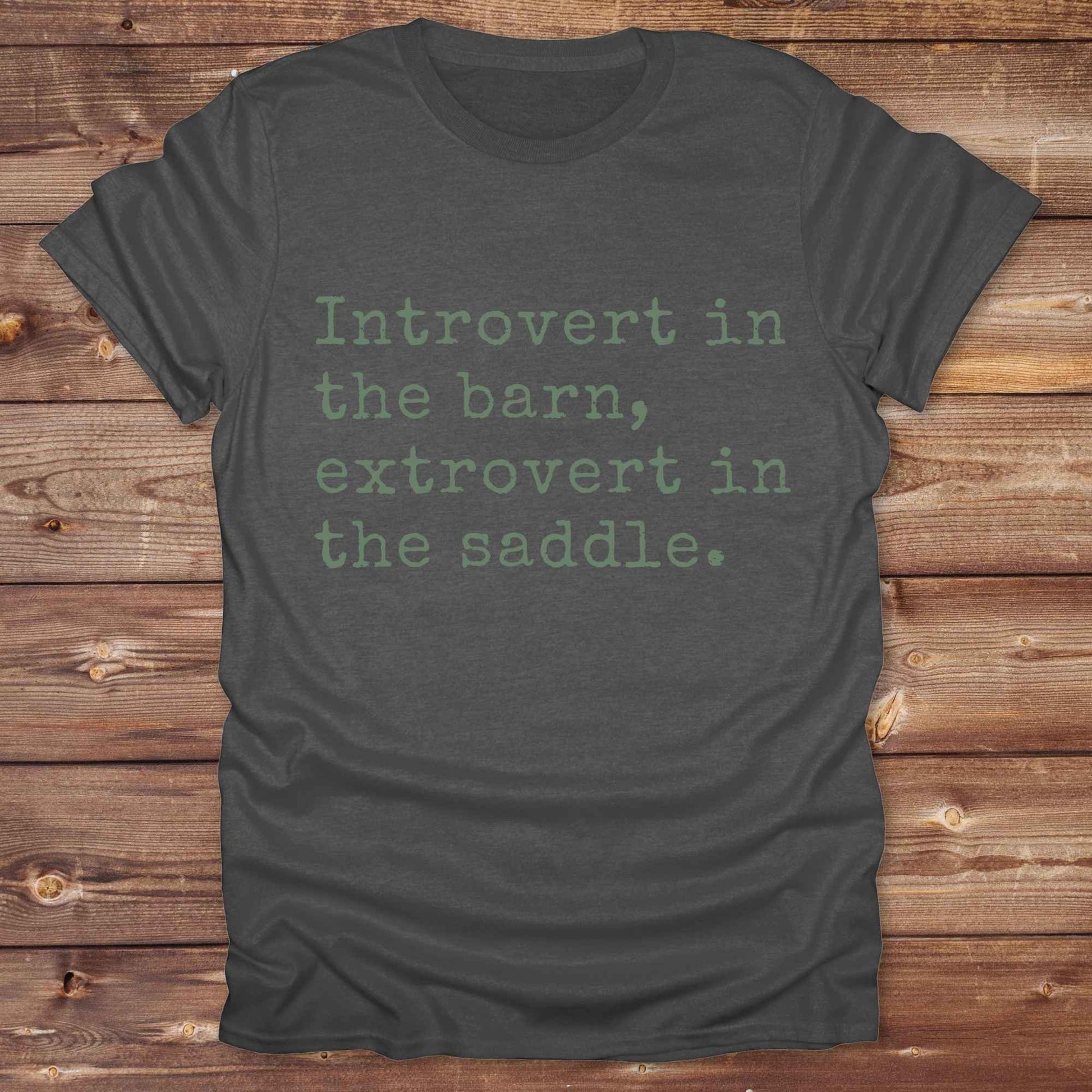“Introvert in the Barn, Extrovert in the Saddle” t-shirt is the ultimate tee for horse lovers, cowgirls, and western introverts. Whether you're quietly mucking stalls or stealing the show in the arena. made for equestrian souls who ride louder than they talk. Designed with comfort in mind, this western quote shirt is perfect for rodeo nights, barn hangs, or gifting a fellow horse girl.