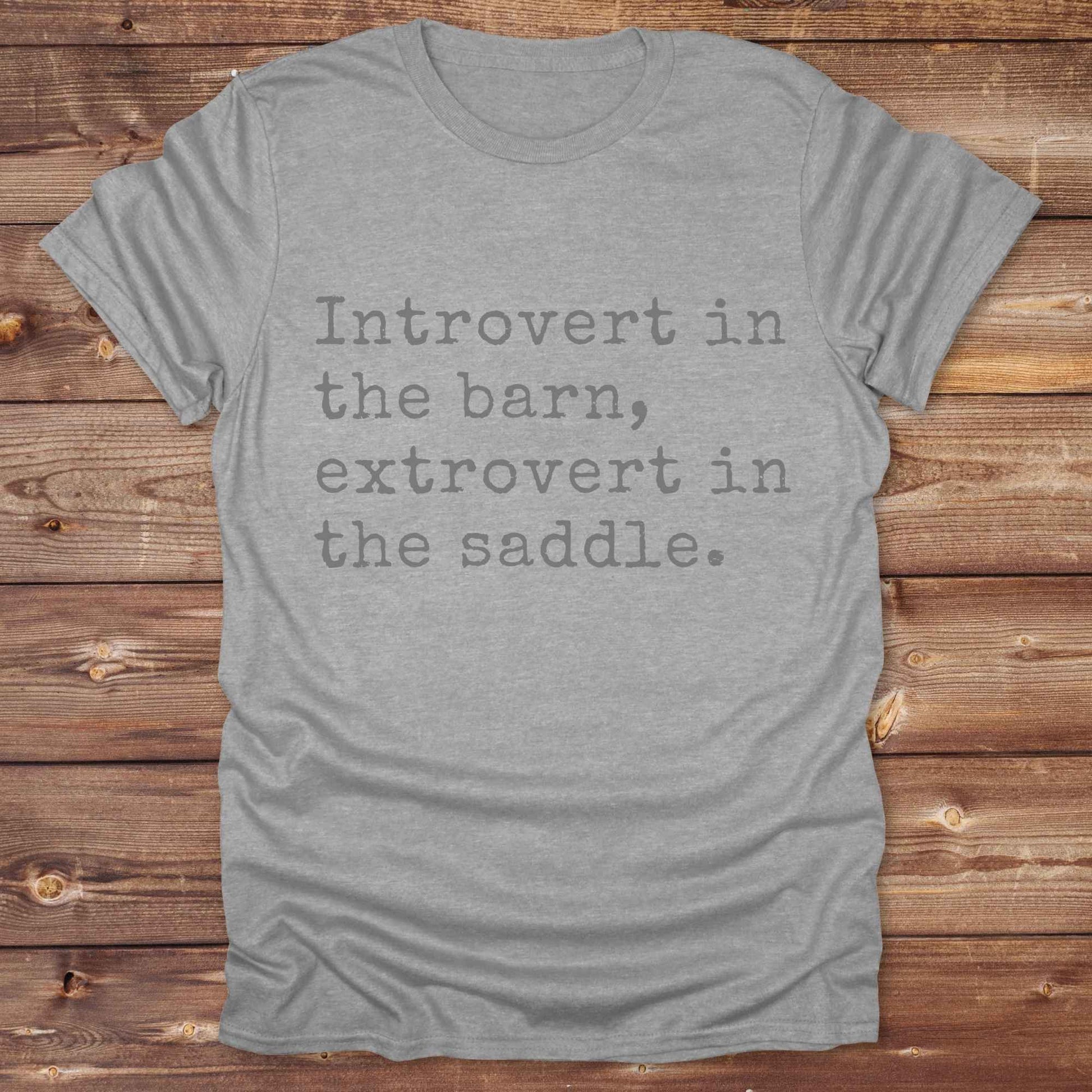 “Introvert in the Barn, Extrovert in the Saddle” t-shirt is the ultimate tee for horse lovers, cowgirls, and western introverts. Whether you're quietly mucking stalls or stealing the show in the arena. made for equestrian souls who ride louder than they talk. Designed with comfort in mind, this western quote shirt is perfect for rodeo nights, barn hangs, or gifting a fellow horse girl.