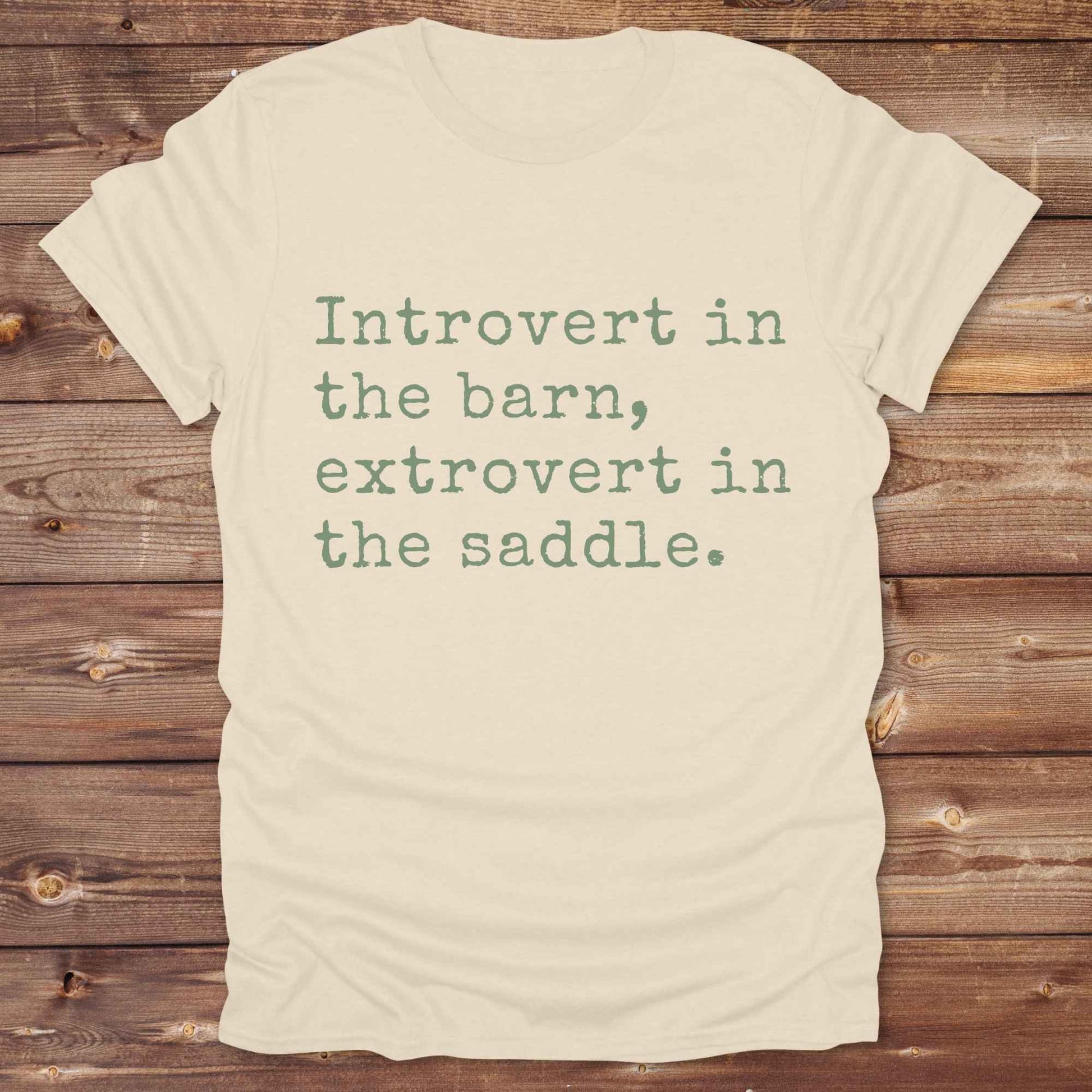 “Introvert in the Barn, Extrovert in the Saddle” t-shirt is the ultimate tee for horse lovers, cowgirls, and western introverts. Whether you're quietly mucking stalls or stealing the show in the arena. made for equestrian souls who ride louder than they talk. Designed with comfort in mind, this western quote shirt is perfect for rodeo nights, barn hangs, or gifting a fellow horse girl.