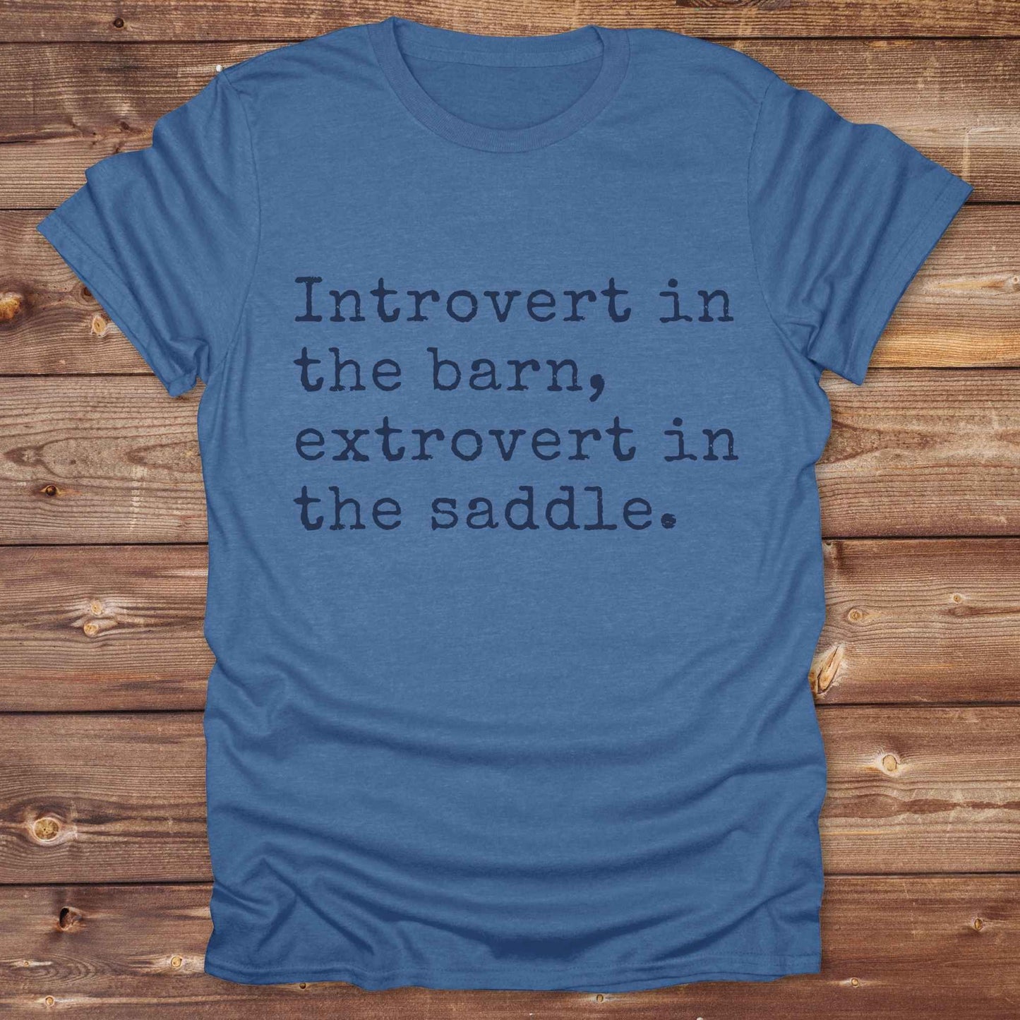 “Introvert in the Barn, Extrovert in the Saddle” t-shirt is the ultimate tee for horse lovers, cowgirls, and western introverts. Whether you're quietly mucking stalls or stealing the show in the arena. made for equestrian souls who ride louder than they talk. Designed with comfort in mind, this western quote shirt is perfect for rodeo nights, barn hangs, or gifting a fellow horse girl.