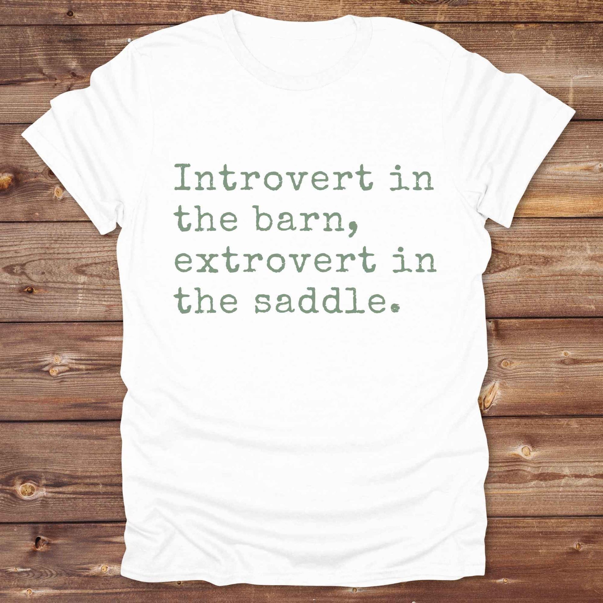 “Introvert in the Barn, Extrovert in the Saddle” t-shirt is the ultimate tee for horse lovers, cowgirls, and western introverts. Whether you're quietly mucking stalls or stealing the show in the arena. made for equestrian souls who ride louder than they talk. Designed with comfort in mind, this western quote shirt is perfect for rodeo nights, barn hangs, or gifting a fellow horse girl.