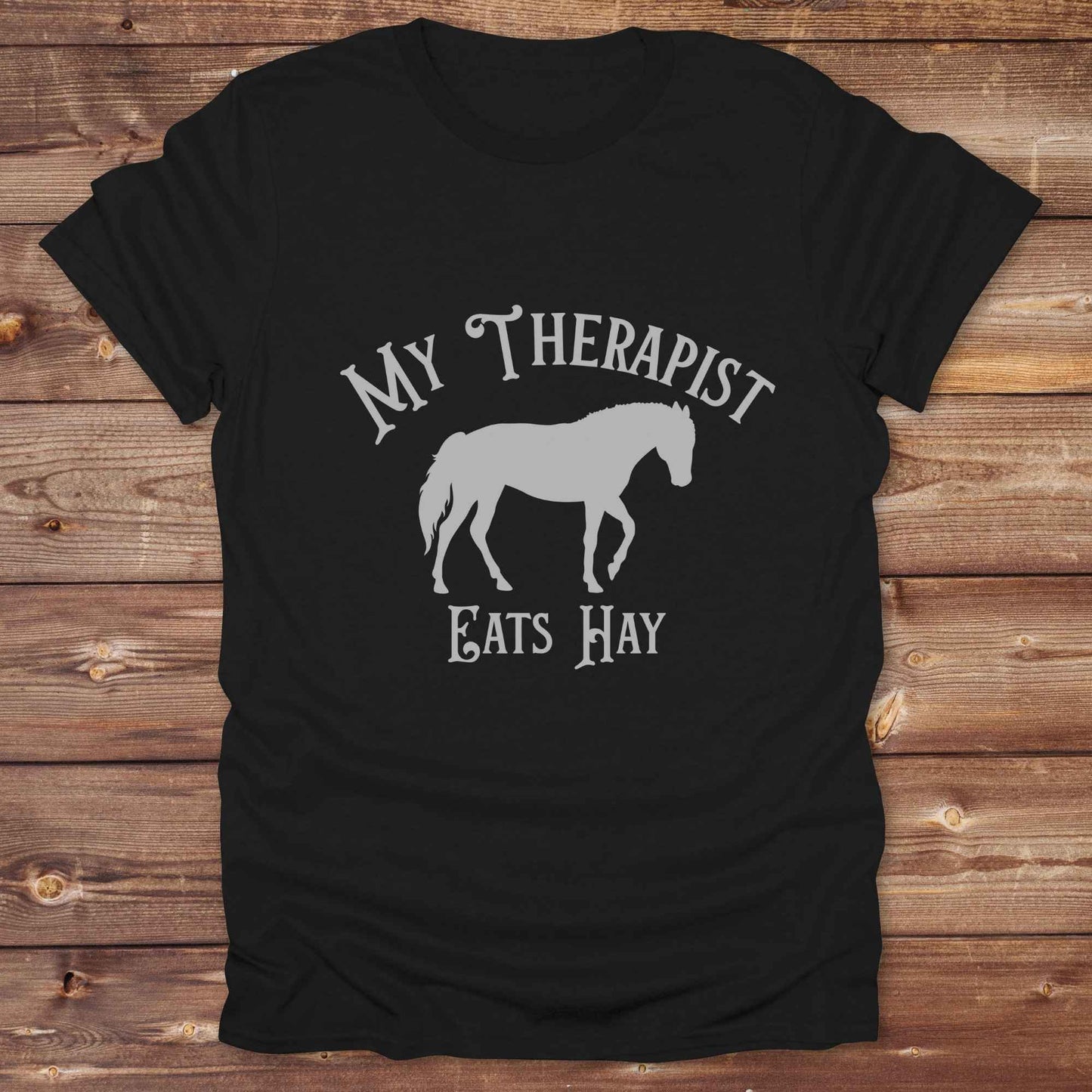 “My Therapist Eats Hay” t-shirt is the perfect mix of humor and horse lover pride, made for cowgirls, cowboys, and western enthusiasts alike. Featuring a bold horse silhouette and vintage western font, it’s ideal for barn days, rodeo nights, or gifting to someone who finds peace in the pasture. Great for birthdays, country events, or just repping your equine therapist with style. Whether you ride for fun or sanity, this western tee keeps the cowboy spirit alive with every wear.