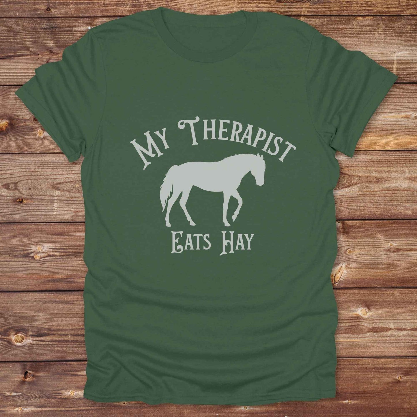 “My Therapist Eats Hay” t-shirt is the perfect mix of humor and horse lover pride, made for cowgirls, cowboys, and western enthusiasts alike. Featuring a bold horse silhouette and vintage western font, it’s ideal for barn days, rodeo nights, or gifting to someone who finds peace in the pasture. Great for birthdays, country events, or just repping your equine therapist with style. Whether you ride for fun or sanity, this western tee keeps the cowboy spirit alive with every wear.