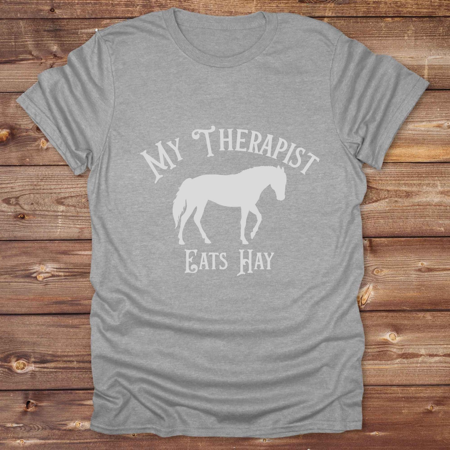 “My Therapist Eats Hay” t-shirt is the perfect mix of humor and horse lover pride, made for cowgirls, cowboys, and western enthusiasts alike. Featuring a bold horse silhouette and vintage western font, it’s ideal for barn days, rodeo nights, or gifting to someone who finds peace in the pasture. Great for birthdays, country events, or just repping your equine therapist with style. Whether you ride for fun or sanity, this western tee keeps the cowboy spirit alive with every wear.