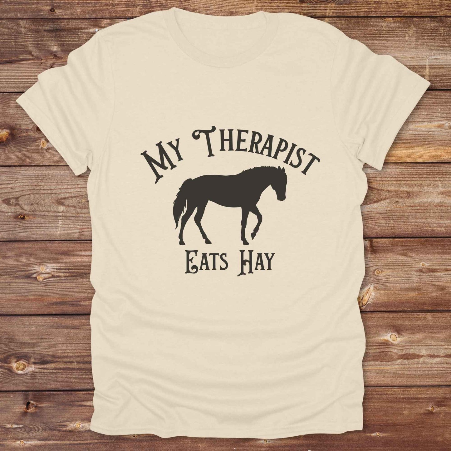 “My Therapist Eats Hay” t-shirt is the perfect mix of humor and horse lover pride, made for cowgirls, cowboys, and western enthusiasts alike. Featuring a bold horse silhouette and vintage western font, it’s ideal for barn days, rodeo nights, or gifting to someone who finds peace in the pasture. Great for birthdays, country events, or just repping your equine therapist with style. Whether you ride for fun or sanity, this western tee keeps the cowboy spirit alive with every wear.