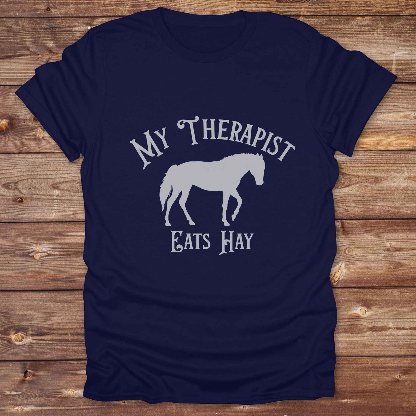 “My Therapist Eats Hay” t-shirt is the perfect mix of humor and horse lover pride, made for cowgirls, cowboys, and western enthusiasts alike. Featuring a bold horse silhouette and vintage western font, it’s ideal for barn days, rodeo nights, or gifting to someone who finds peace in the pasture. Great for birthdays, country events, or just repping your equine therapist with style. Whether you ride for fun or sanity, this western tee keeps the cowboy spirit alive with every wear.