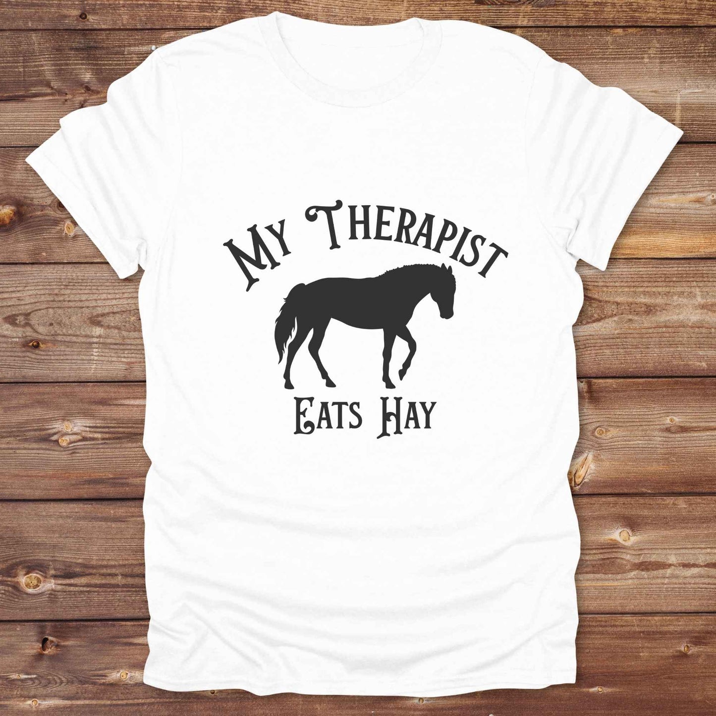 “My Therapist Eats Hay” t-shirt is the perfect mix of humor and horse lover pride, made for cowgirls, cowboys, and western enthusiasts alike. Featuring a bold horse silhouette and vintage western font, it’s ideal for barn days, rodeo nights, or gifting to someone who finds peace in the pasture. Great for birthdays, country events, or just repping your equine therapist with style. Whether you ride for fun or sanity, this western tee keeps the cowboy spirit alive with every wear.
