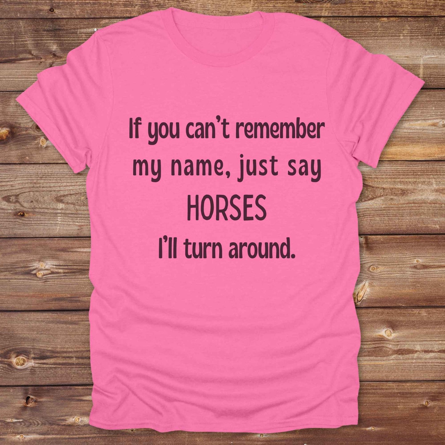 Get noticed with our hilarious “If You Can’t Remember My Name, Shout Horses” t-shirt designed for cowgirls, cowboys, and horse lovers who live for western humor and barn life. This bold, rustic graphic tee is a perfect gift for birthdays, rodeo events, or just showing off your horse obsession. Made for comfort and laughs, it's the ideal shirt for stables, trail rides, and every country concert. Cowgirl up and shout your style loud and proud. From rustic charm to rodeo ready sass, this shirt says it all!