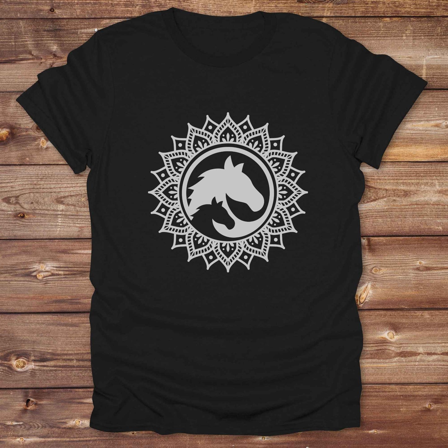 Mandala Horse T-Shirt combines boho spirituality and western soul, perfect for cowgirls, cowboys, horse lovers, and rodeo fans. Features an intricate mandala design with a majestic horse at the center, this tee speaks to those who love rustic country style with spiritual flair. Whether you're trail riding, heading to a barn dance, or simply showing off your equestrian pride, this shirt is the ideal blend of comfort and expression. Designed for mindful western wearers and horse lovers alike, birthdays