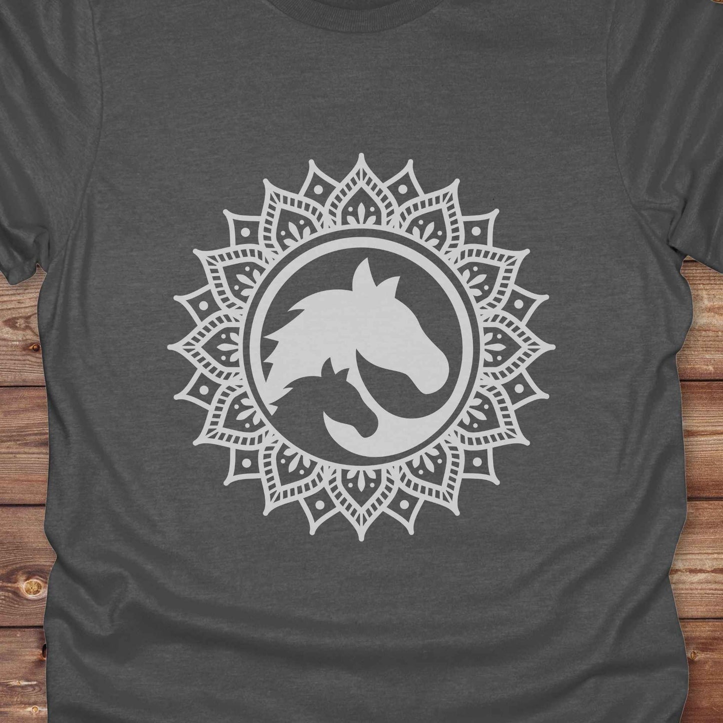 Mandala Horse T-Shirt combines boho spirituality and western soul, perfect for cowgirls, cowboys, horse lovers, and rodeo fans. Features an intricate mandala design with a majestic horse at the center, this tee speaks to those who love rustic country style with spiritual flair. Whether you're trail riding, heading to a barn dance, or simply showing off your equestrian pride, this shirt is the ideal blend of comfort and expression. Designed for mindful western wearers and horse lovers alike, birthdays