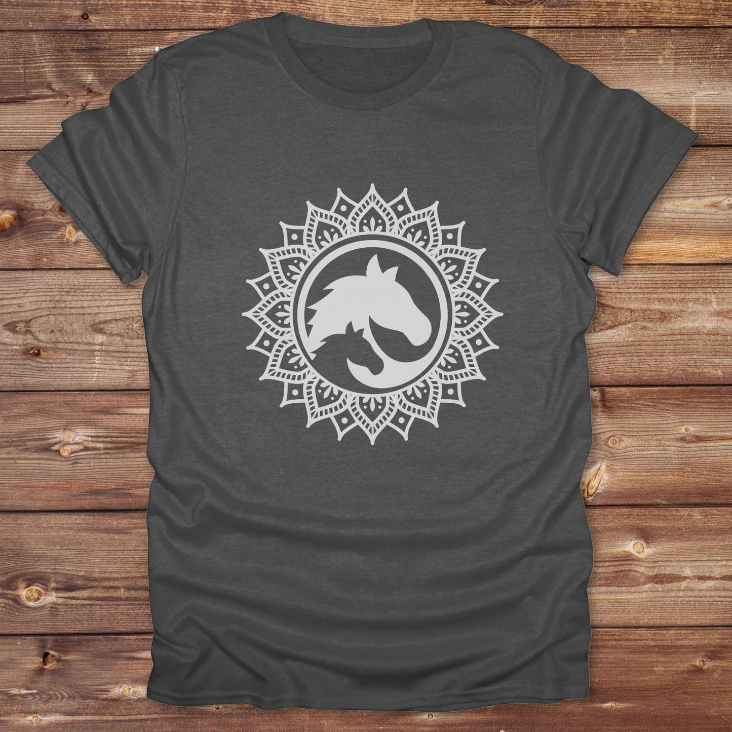 Mandala Horse T-Shirt combines boho spirituality and western soul, perfect for cowgirls, cowboys, horse lovers, and rodeo fans. Features an intricate mandala design with a majestic horse at the center, this tee speaks to those who love rustic country style with spiritual flair. Whether you're trail riding, heading to a barn dance, or simply showing off your equestrian pride, this shirt is the ideal blend of comfort and expression. Designed for mindful western wearers and horse lovers alike, birthdays