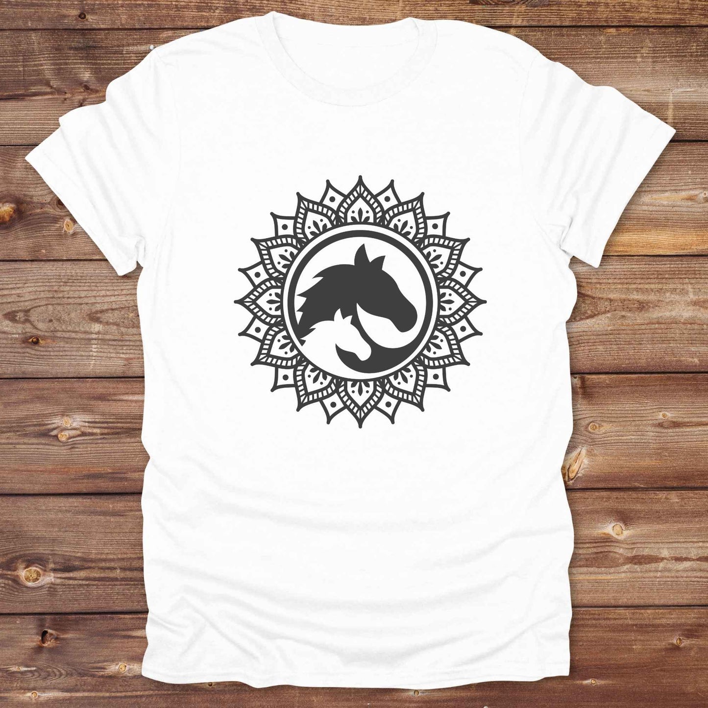 Mandala Horse T-Shirt combines boho spirituality and western soul, perfect for cowgirls, cowboys, horse lovers, and rodeo fans. Features an intricate mandala design with a majestic horse at the center, this tee speaks to those who love rustic country style with spiritual flair. Whether you're trail riding, heading to a barn dance, or simply showing off your equestrian pride, this shirt is the ideal blend of comfort and expression. Designed for mindful western wearers and horse lovers alike, birthdays