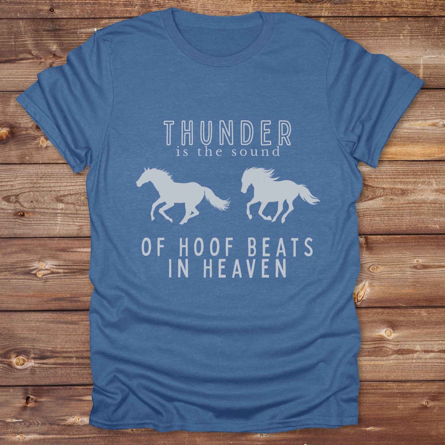 Saddle up with our “Hoof Beats in Heaven” Western Tee – the perfect tribute to your love for horses, riding, and country life. Featuring bold galloping horse graphics and the quote “Thunder is the sound of hoof beats in heaven,” this shirt is made for cowgirls, cowboys, and western soul seekers. Ideal for rodeo lovers, country music fans, and horse memorial gifts. It’s a versatile piece for ranch days, casual outings, or as a thoughtful gift.
