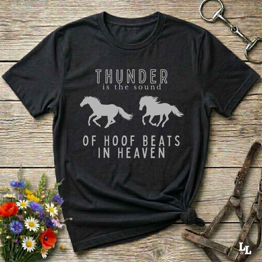 Black tee. Saddle up with our “Hoof Beats in Heaven” Western Tee – the perfect tribute to your love for horses, riding, and country life. Featuring bold galloping horse graphics and the quote “Thunder is the sound of hoof beats in heaven,” this shirt is made for cowgirls, cowboys, and western soul seekers. Ideal for rodeo lovers, country music fans, and horse memorial gifts. It’s a versatile piece for ranch days, casual outings, or as a thoughtful gift.