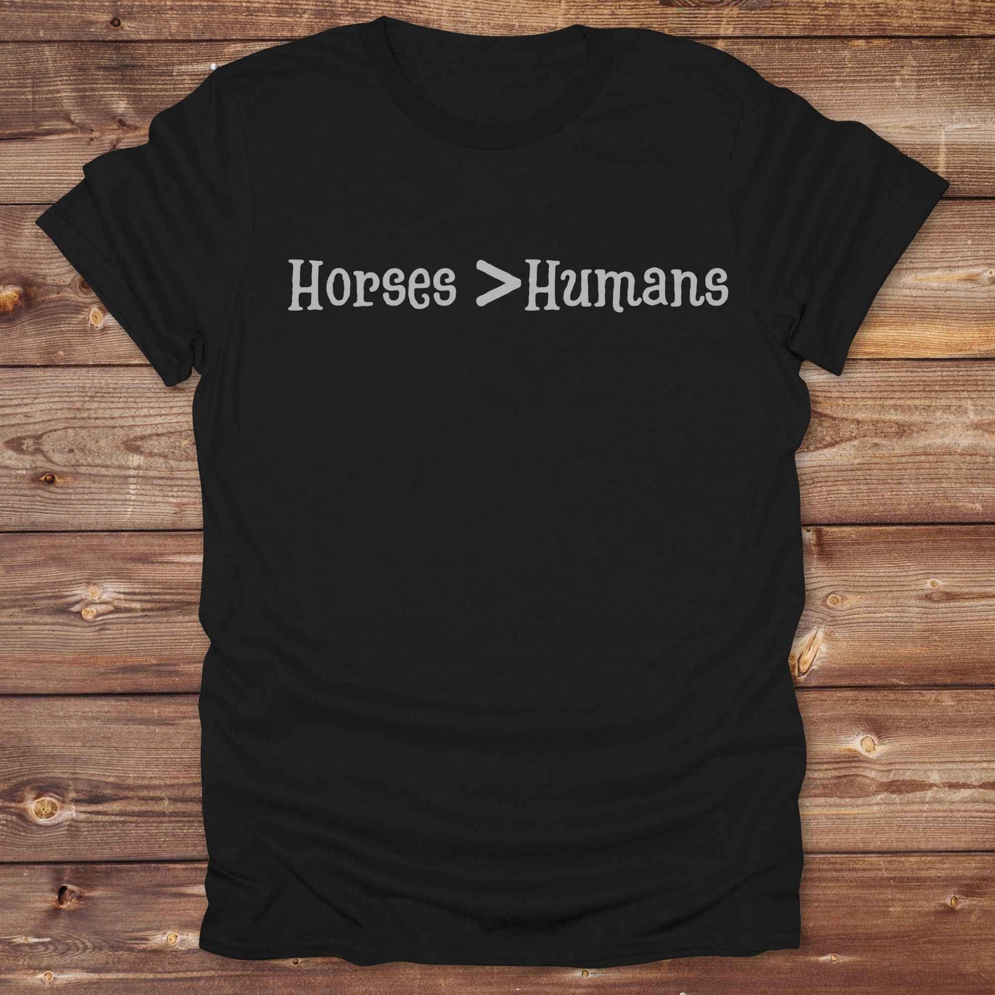 Show off your equestrian spirit with our “Horses > Humans” western t-shirt — made for horse lovers with a sense of humor. This minimal black design says it all: horses are better than people, period. Perfect for cowgirls, cowboys, equestrians, rodeo fans, and sarcastic ranch folk who know where their loyalty lies. Whether you're gifting it to a horse girl or repping it at a rodeo, this tee delivers comfort, country attitude, and all the sass.