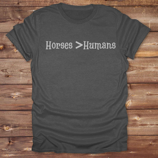 Show off your equestrian spirit with our “Horses > Humans” western t-shirt — made for horse lovers with a sense of humor. This minimal black design says it all: horses are better than people, period. Perfect for cowgirls, cowboys, equestrians, rodeo fans, and sarcastic ranch folk who know where their loyalty lies. Whether you're gifting it to a horse girl or repping it at a rodeo, this tee delivers comfort, country attitude, and all the sass.