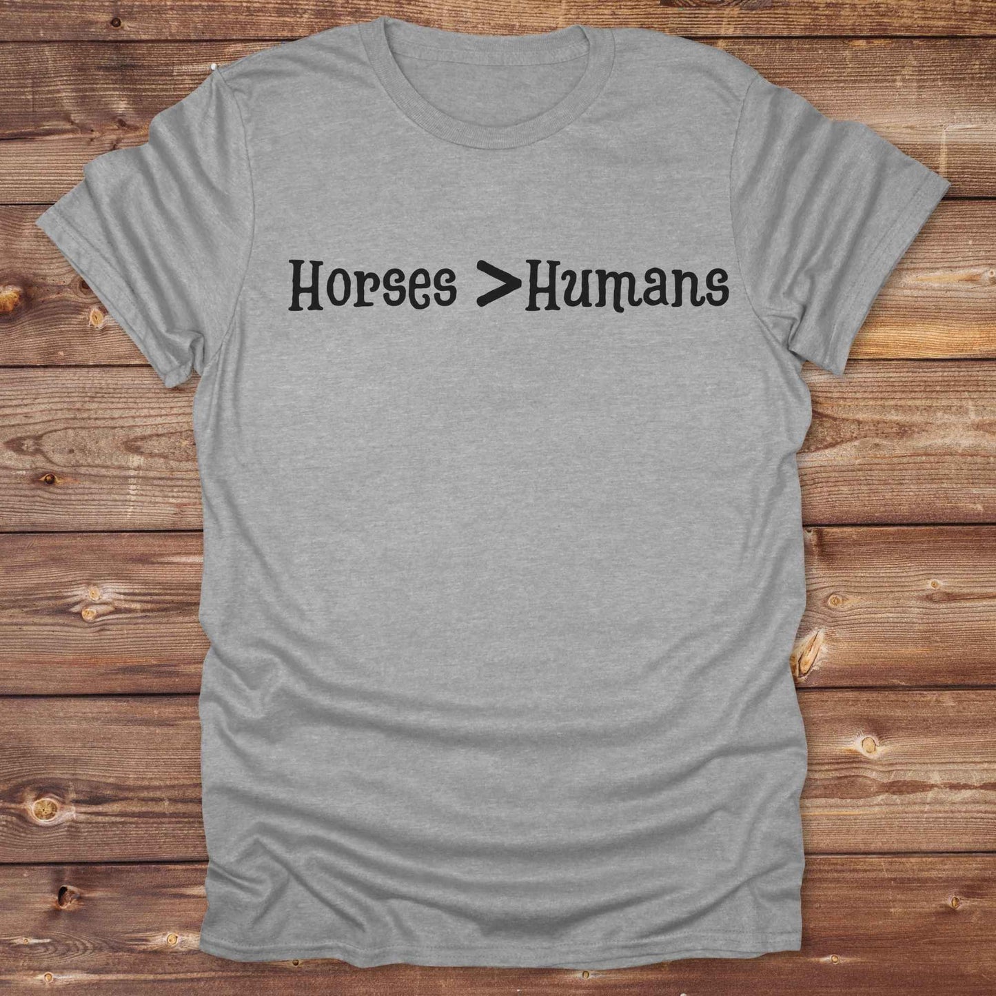 Show off your equestrian spirit with our “Horses > Humans” western t-shirt — made for horse lovers with a sense of humor. This minimal black design says it all: horses are better than people, period. Perfect for cowgirls, cowboys, equestrians, rodeo fans, and sarcastic ranch folk who know where their loyalty lies. Whether you're gifting it to a horse girl or repping it at a rodeo, this tee delivers comfort, country attitude, and all the sass.