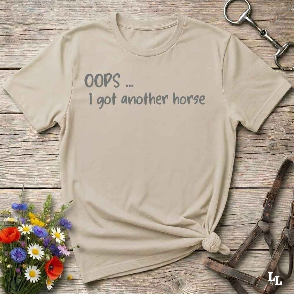 A beige graphic t-shirt with the text 'OOPS .... I got another horse'