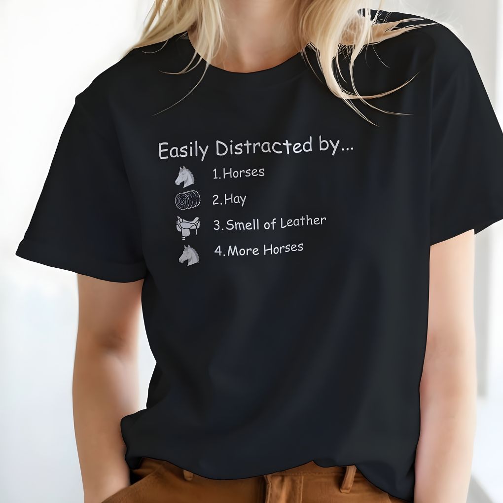 Person wearing a black t-shirt with humorous text and horse-related graphics. Easily Distracted by Horses T-shirt for Horse Lovers, Riding Tee Equestrian Wear
