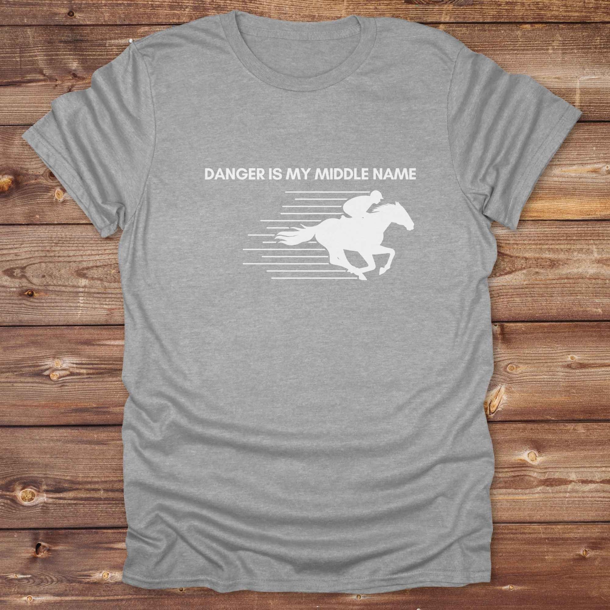 Fun western t-shirt for horse lovers and cowgirls. Western cowgirl graphic tee with horse design. Cowboy humor t-shirt for rodeo and country lovers. Horse lover funny t-shirt with western theme. Country style horse graphic tee for cowboys and cowgirls. Retro style funny western shirt for equestrians. Cute and funny country shirt with horse print. Southern cowgirl funny quote shirt for horse lovers. Danger is my middle name with fast horse.