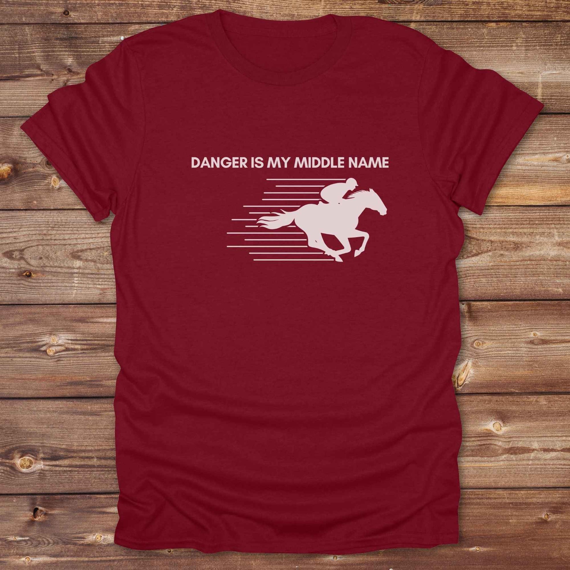 Fun western t-shirt for horse lovers and cowgirls. Western cowgirl graphic tee with horse design. Cowboy humor t-shirt for rodeo and country lovers. Horse lover funny t-shirt with western theme. Country style horse graphic tee for cowboys and cowgirls. Retro style funny western shirt for equestrians. Cute and funny country shirt with horse print. Southern cowgirl funny quote shirt for horse lovers. Danger is my middle name with fast horse.