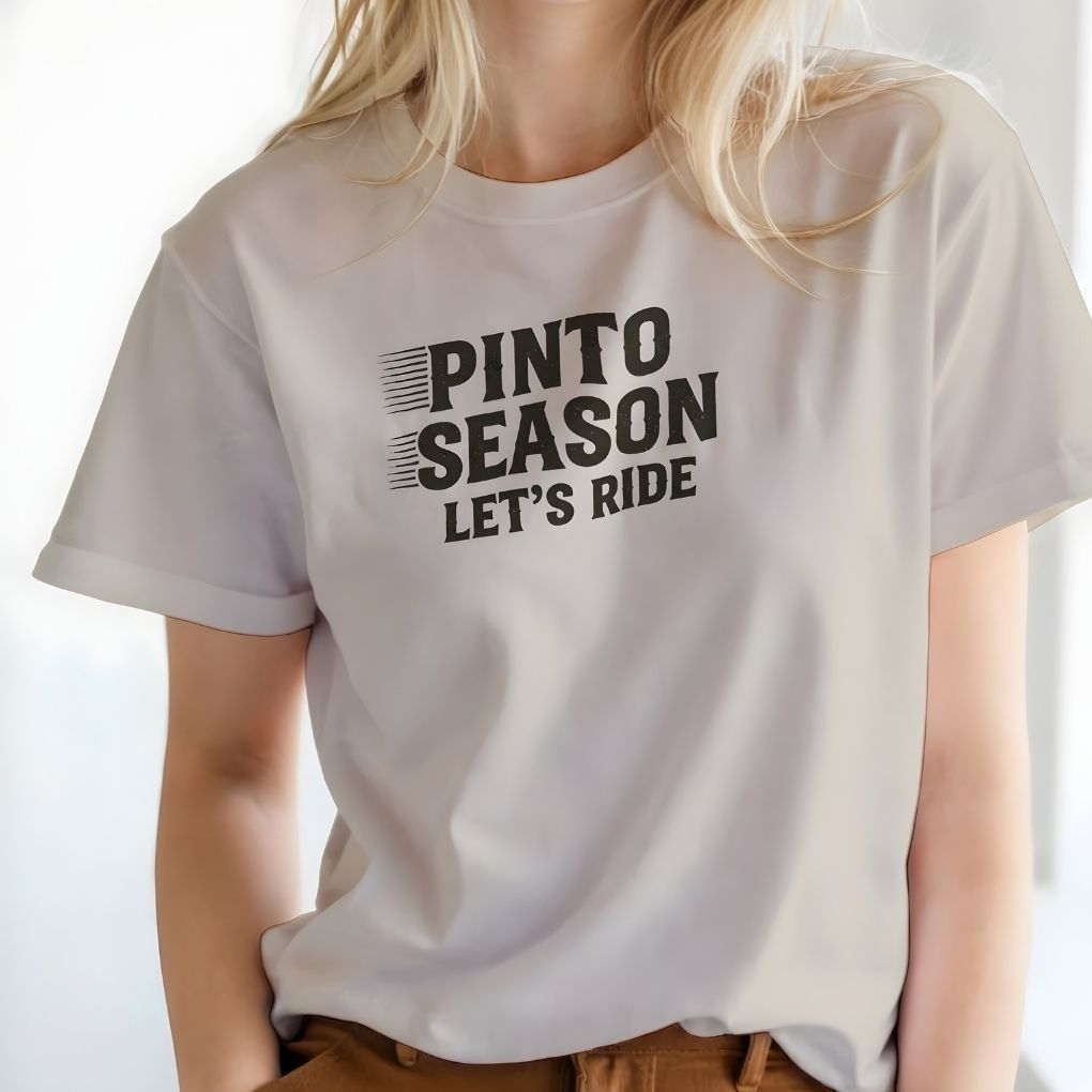 White t-shirt with 'Pinto Season Let's Ride' text worn by a person on a white background. Pinto Season Let's Ride T-Shirt for Pinto Horse Lovers, Trail Riding Tee