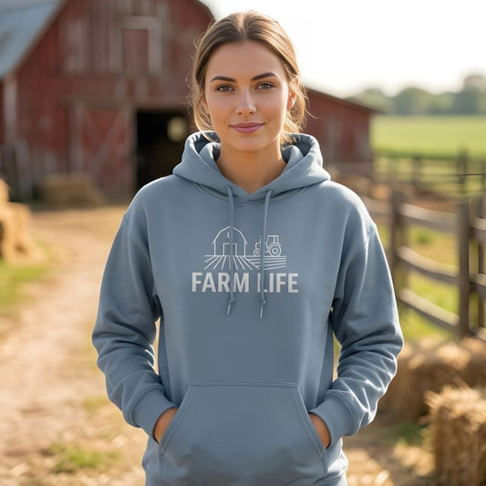 Woman wearing a gray hoodie with 'Farm Life' text and tractor graphic in front of a red barn. Farm Life Hoodie for Horse Riders, Outdoor Hoodie, Farmers Barn Wear