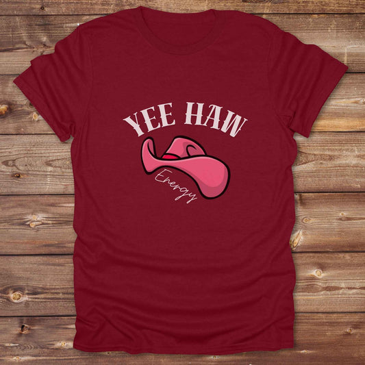 Fun western t-shirt for horse lovers and cowgirls. Western cowgirl graphic tee with horse design. Cowboy humor t-shirt for rodeo and country lovers. Horse lover funny t-shirt with western theme. Country style horse graphic tee for cowboys and cowgirls. Retro style funny western shirt for equestrians. Cute and funny country shirt with horse print. Southern cowgirl funny quote shirt for horse lovers. Yee Haw Energy with Pink Cowgirl Hat.