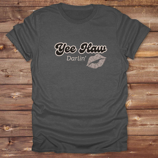 Fun western t-shirt for horse lovers and cowgirls. Western cowgirl graphic tee with horse design. Cowboy humor t-shirt for rodeo and country lovers. Horse lover funny t-shirt with western theme. Country style horse graphic tee for cowboys and cowgirls. Retro style funny western shirt for equestrians. Cute and funny country shirt with horse print. Southern cowgirl funny quote shirt for horse lovers. Yee Haw Darlin' Kiss.