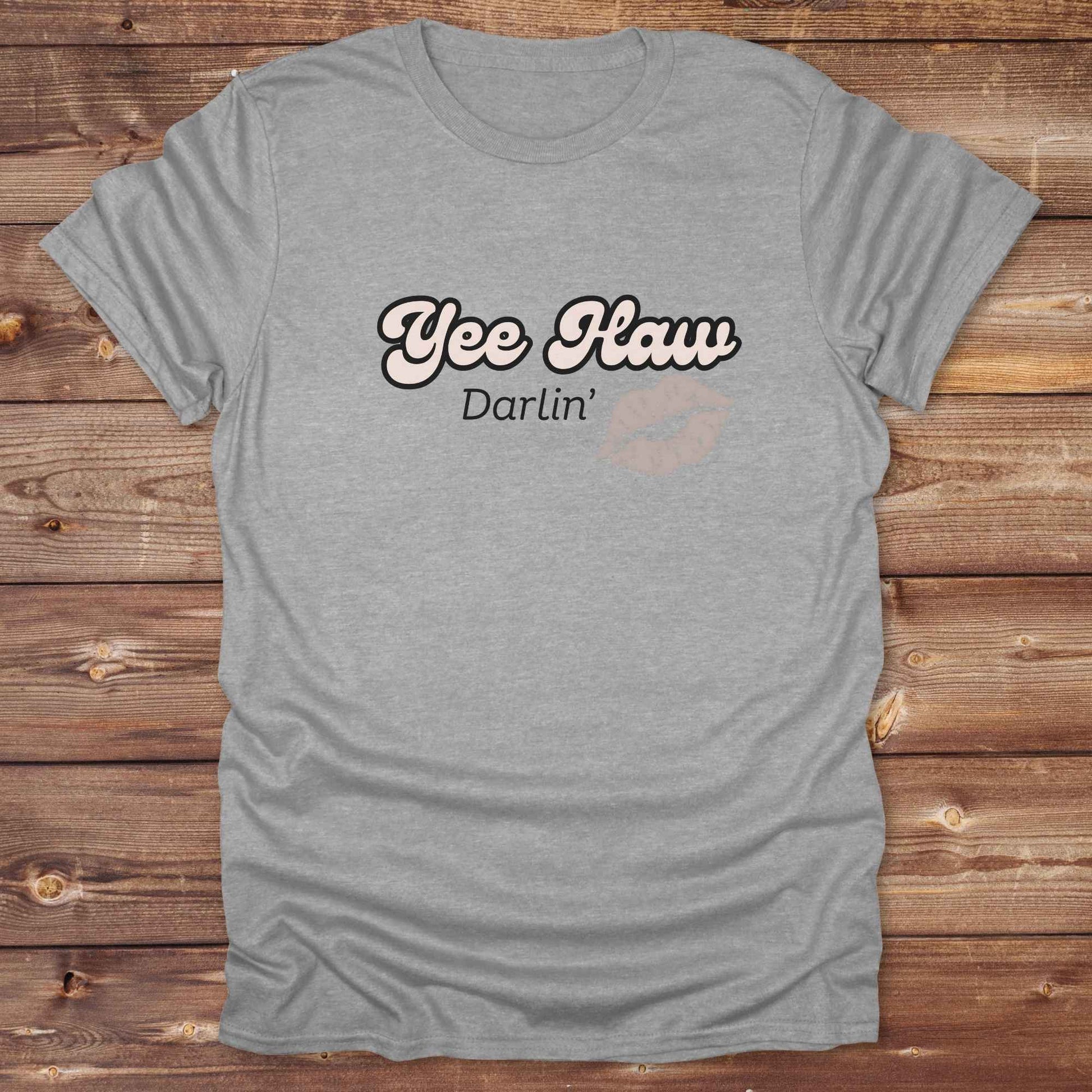 Fun western t-shirt for horse lovers and cowgirls. Western cowgirl graphic tee with horse design. Cowboy humor t-shirt for rodeo and country lovers. Horse lover funny t-shirt with western theme. Country style horse graphic tee for cowboys and cowgirls. Retro style funny western shirt for equestrians. Cute and funny country shirt with horse print. Southern cowgirl funny quote shirt for horse lovers. Yee Haw Darlin' Kiss.