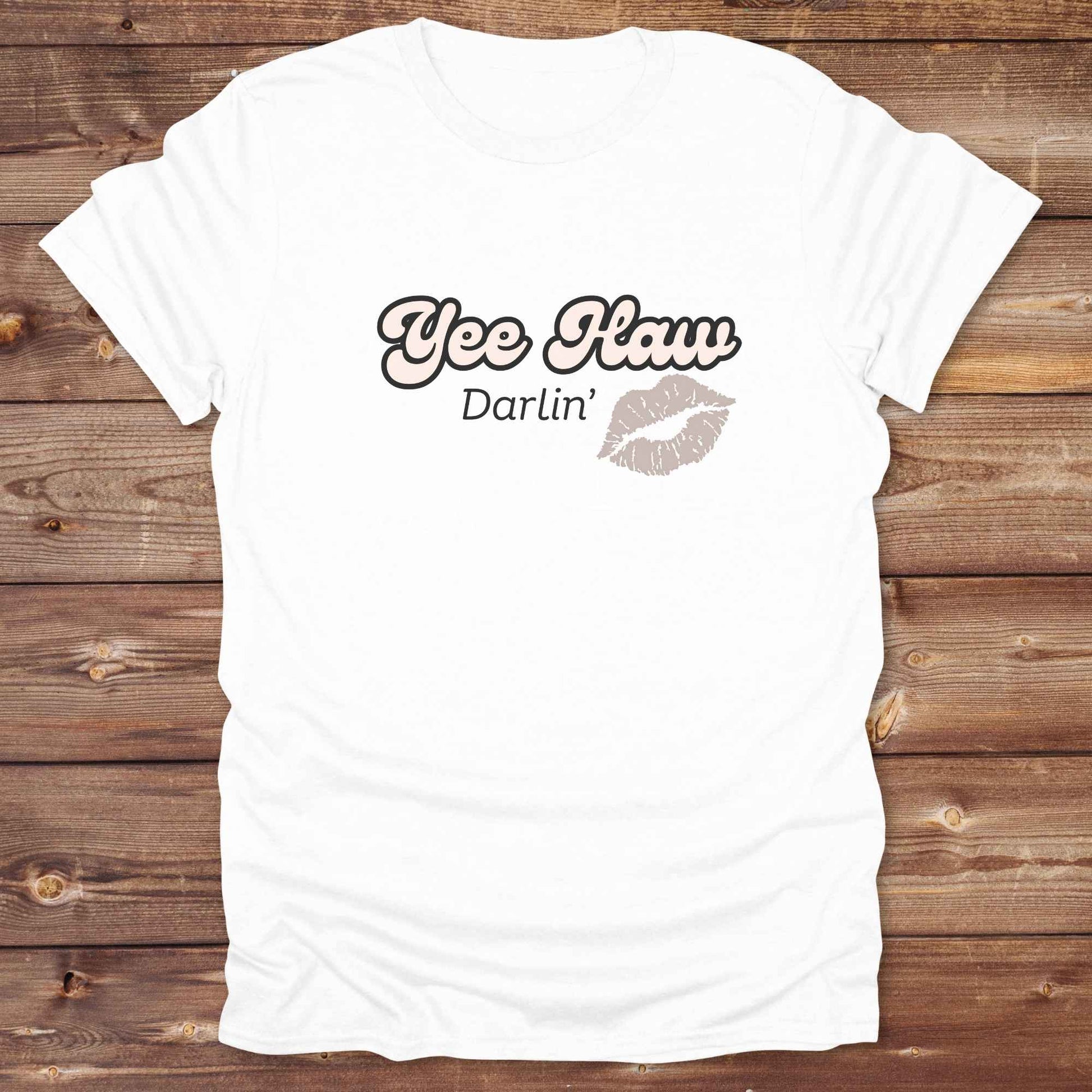 Fun western t-shirt for horse lovers and cowgirls. Western cowgirl graphic tee with horse design. Cowboy humor t-shirt for rodeo and country lovers. Horse lover funny t-shirt with western theme. Country style horse graphic tee for cowboys and cowgirls. Retro style funny western shirt for equestrians. Cute and funny country shirt with horse print. Southern cowgirl funny quote shirt for horse lovers. Yee Haw Darlin' Kiss.