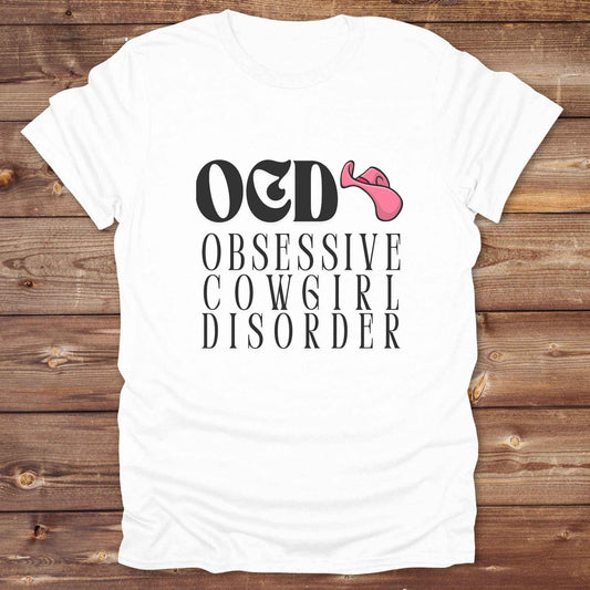 Fun western t-shirt for horse lovers and cowgirls. Western cowgirl graphic tee with horse design. Cowboy humor t-shirt for rodeo and country lovers. Horse lover funny t-shirt with western theme. Country style horse graphic tee for cowboys and cowgirls. Retro style funny western shirt for equestrians. Cute and funny country shirt with horse print. Southern cowgirl funny quote shirt for horse lovers. OCD Cowgirl.
