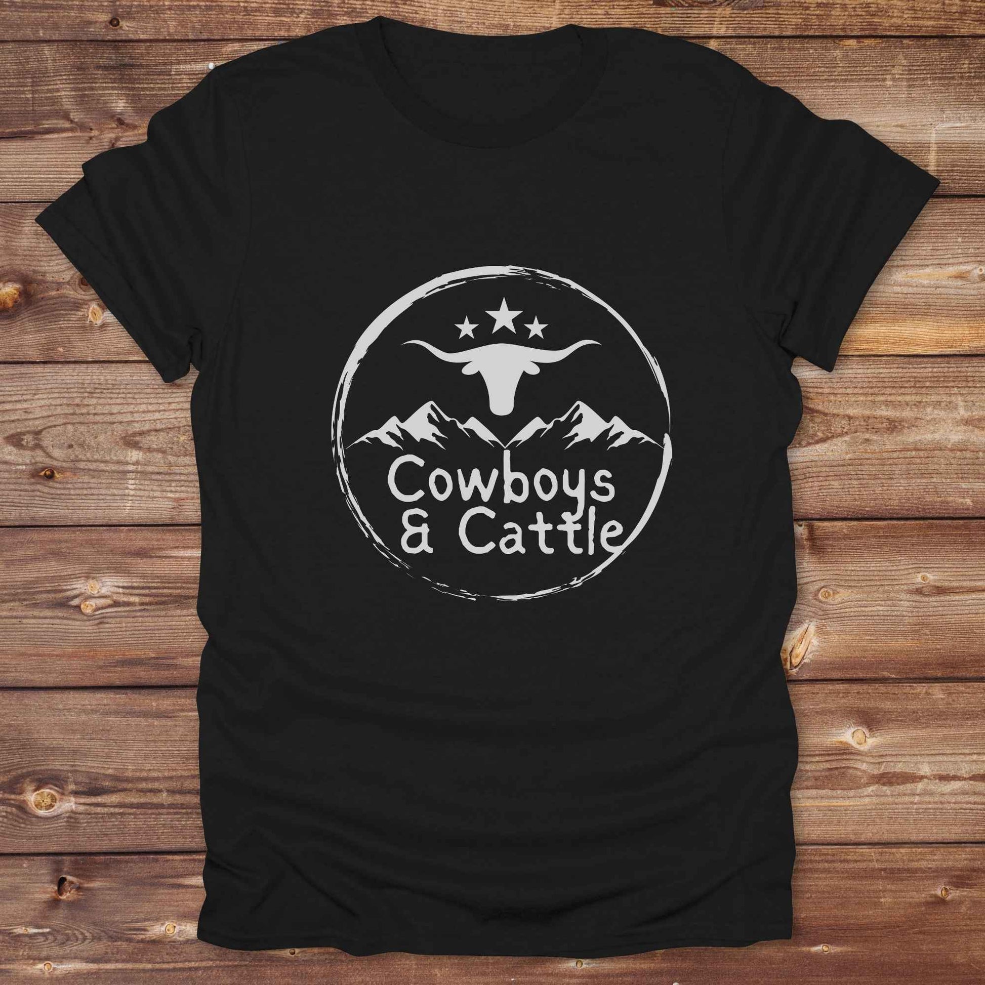 Fun western t-shirt featuring horse themed design for cowgirls, cowboys, horse lovers and equestrians, perfect for rodeo lovers, rustic style fans, and horse people. Unique graphic tee by Lasso and Loom.  Cowboys and cattle with mountain range and longhorn skull.