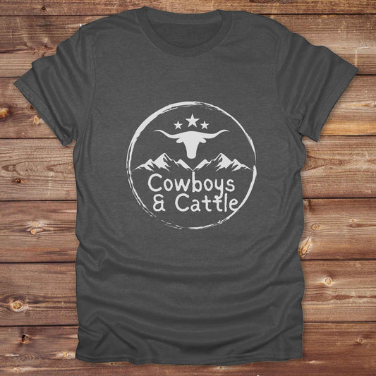 Fun western t-shirt featuring horse themed design for cowgirls, cowboys, horse lovers and equestrians, perfect for rodeo lovers, rustic style fans, and horse people. Unique graphic tee by Lasso and Loom.  Cowboys and cattle with mountain range and longhorn skull.