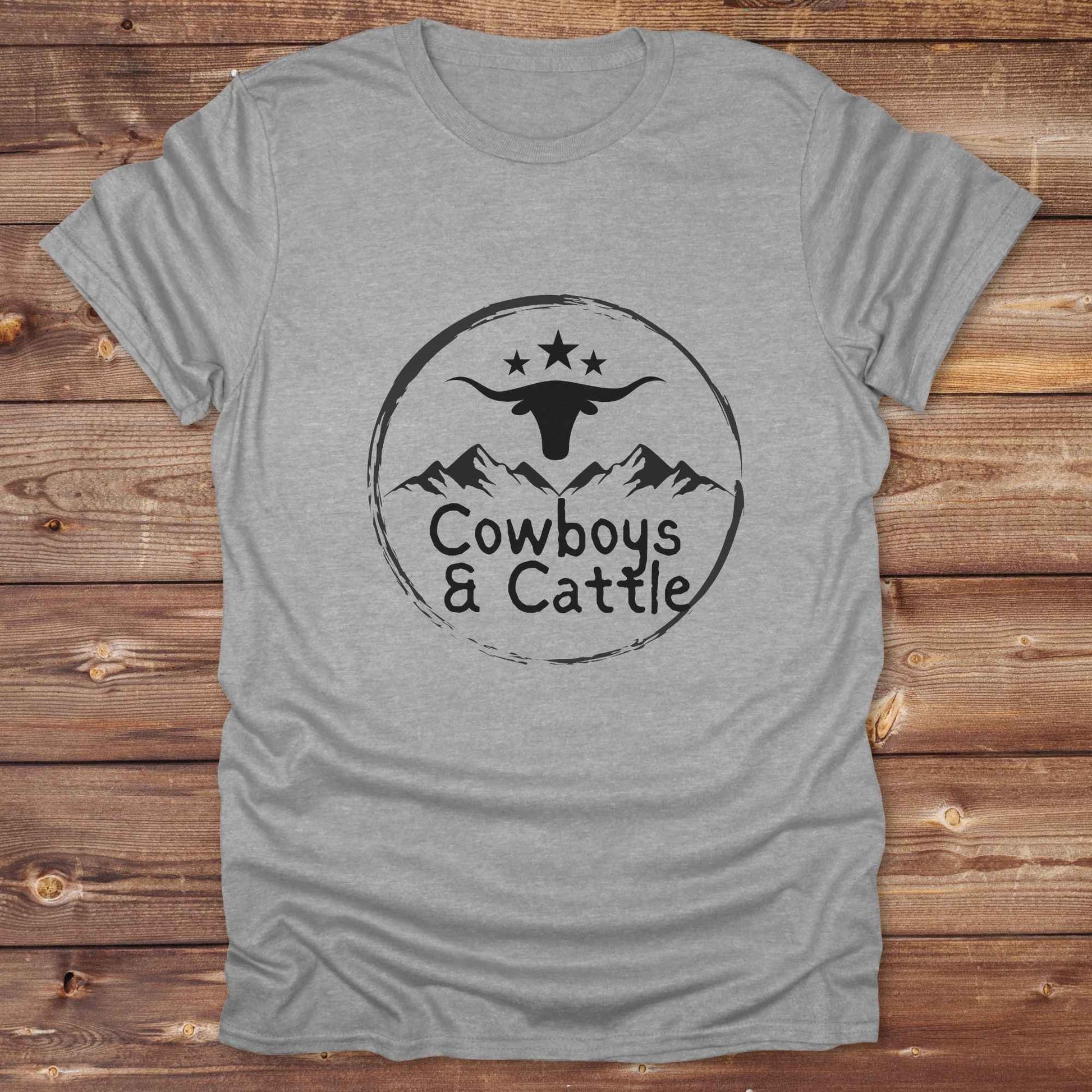 Fun western t-shirt featuring horse themed design for cowgirls, cowboys, horse lovers and equestrians, perfect for rodeo lovers, rustic style fans, and horse people. Unique graphic tee by Lasso and Loom.  Cowboys and cattle with mountain range and longhorn skull.