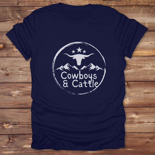 Fun western t-shirt featuring horse themed design for cowgirls, cowboys, horse lovers and equestrians, perfect for rodeo lovers, rustic style fans, and horse people. Unique graphic tee by Lasso and Loom.  Cowboys and cattle with mountain range and longhorn skull.