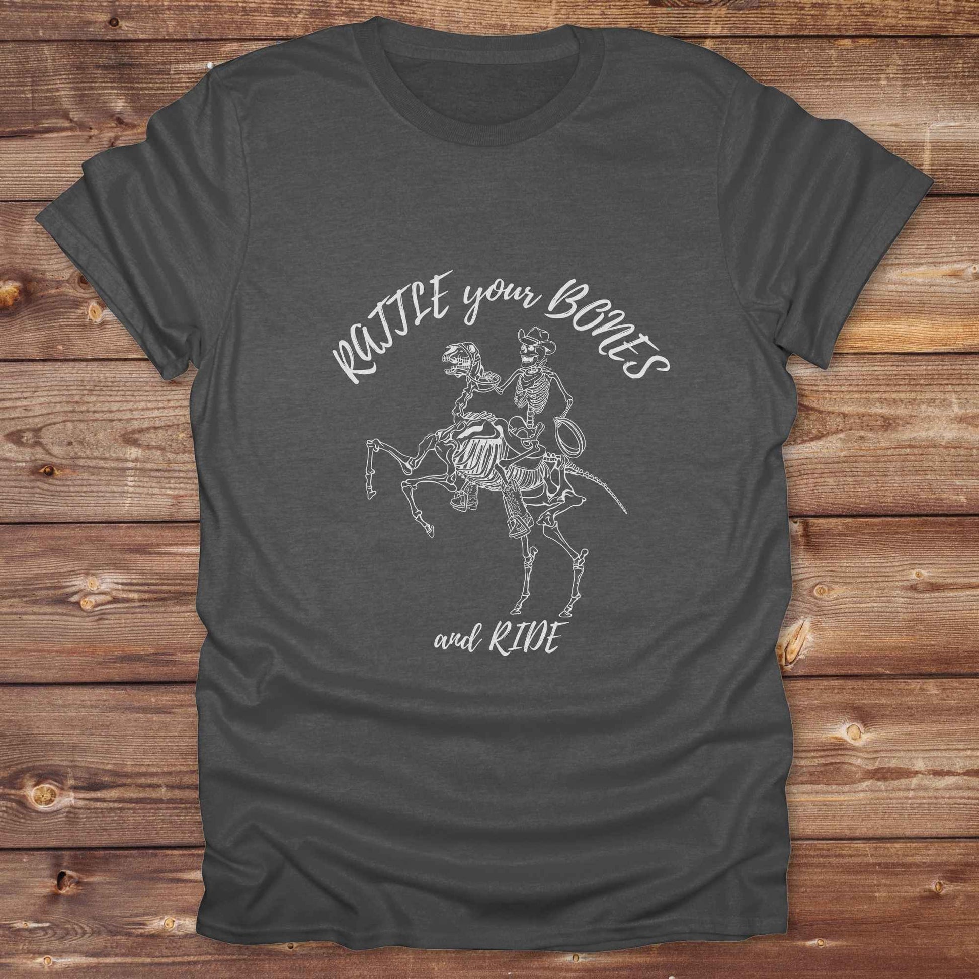 Fun western t-shirt featuring horse themed design for cowgirls, cowboys, horse lovers and equestrians, perfect for rodeo lovers, rustic style fans, and horse people. Unique graphic tee by Lasso and Loom.  Rattle your bones and ride.