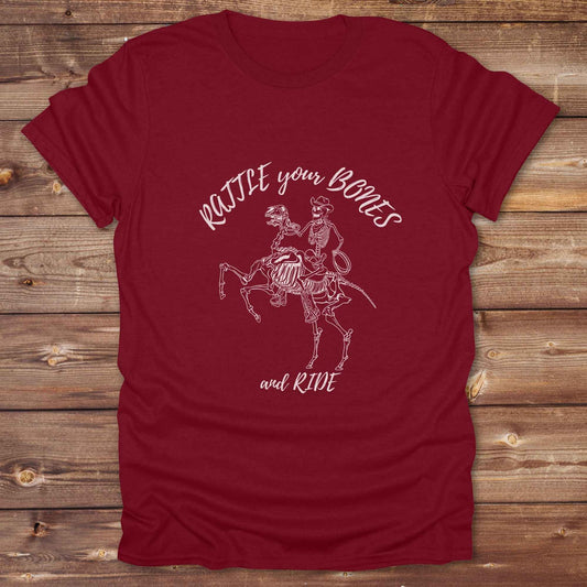 Fun western t-shirt featuring horse themed design for cowgirls, cowboys, horse lovers and equestrians, perfect for rodeo lovers, rustic style fans, and horse people. Unique graphic tee by Lasso and Loom.  Rattle your bones and ride.