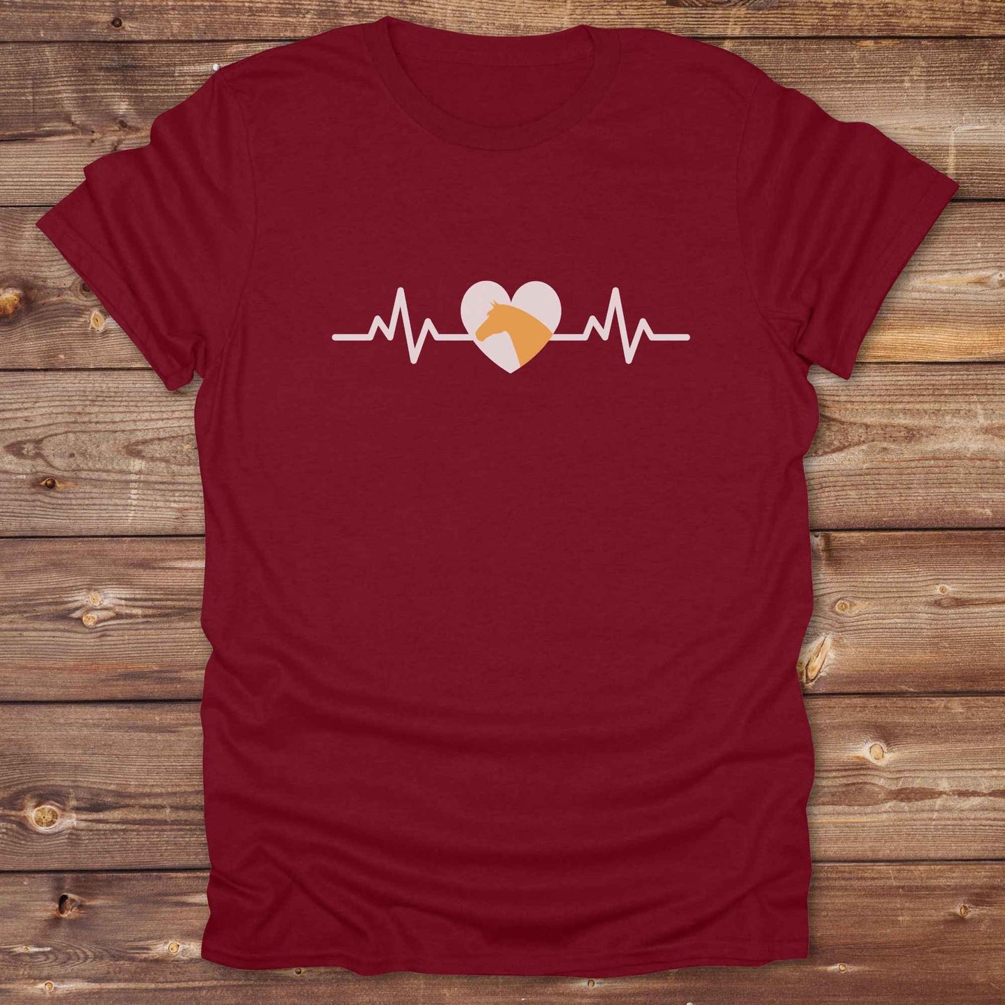 Fun western t-shirt featuring horse themed design for cowgirls, cowboys, horse lovers and equestrians, perfect for rodeo lovers, rustic style fans, and horse people. Unique graphic tee by Lasso and Loom. Heartbeat with a horse in orange.
