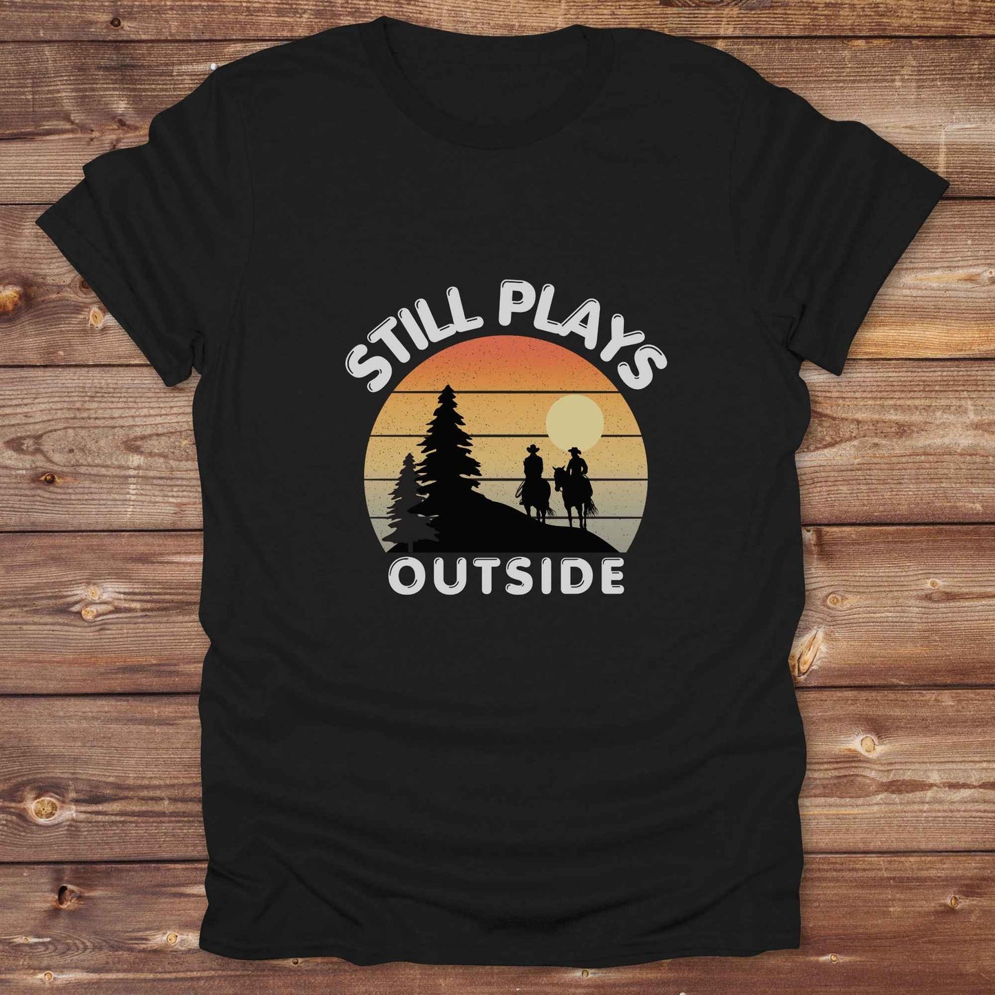 Still plays outside. Funny western t-shirt featuring horse-themed design for cowgirls, cowboys, and equestrians — perfect for rodeo lovers, rustic style fans, and horse people. Unique graphic tee by Lasso and Loom.