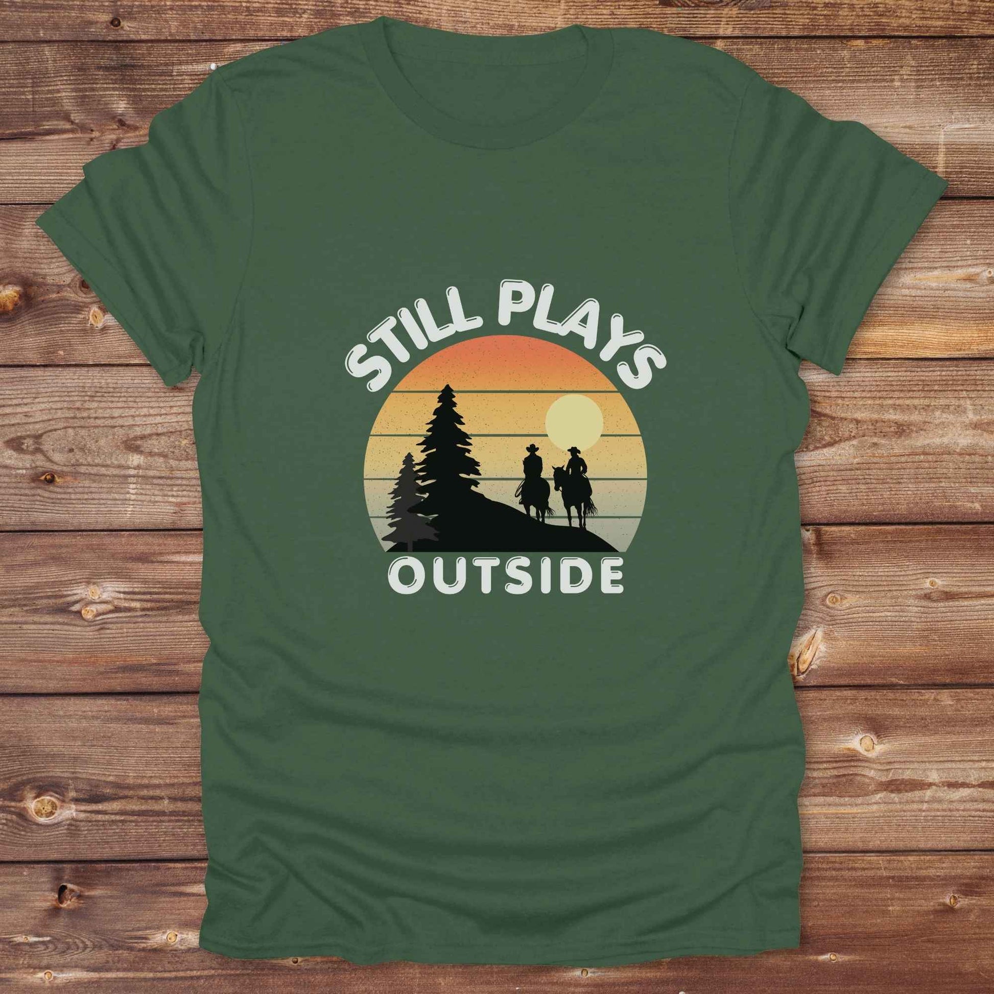 Still plays outside. Funny western t-shirt featuring horse-themed design for cowgirls, cowboys, and equestrians — perfect for rodeo lovers, rustic style fans, and horse people. Unique graphic tee by Lasso and Loom.