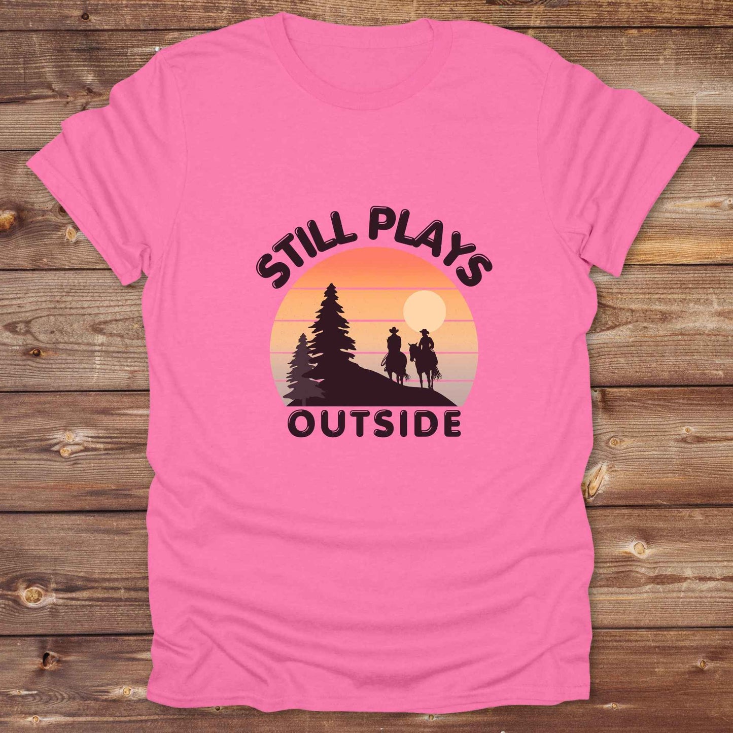 Still plays outside. Funny western t-shirt featuring horse themed design for cowgirls, cowboys, and equestrians — perfect for rodeo lovers, rustic style fans, and horse people. Unique graphic tee by Lasso and Loom.