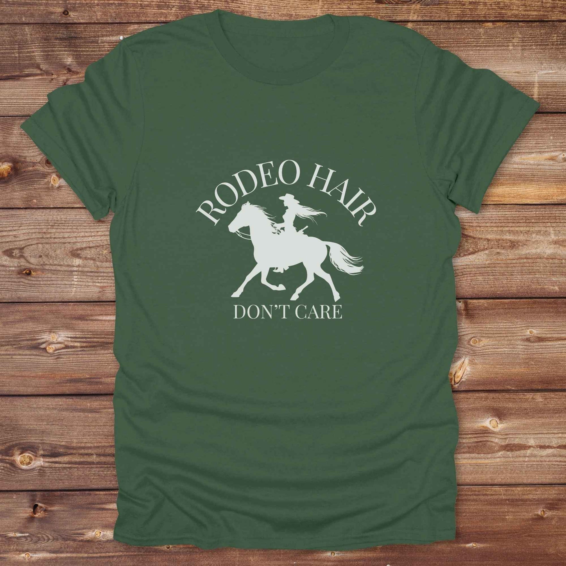ypography cowgirl t-shirt styled for rodeo lovers and horse girls on rustic wooden background. Trendy cowgirl shirt designed for horse lovers, featuring bold western lettering in graphic style. Horse riding themed t-shirt with country slogan “Rodeo Hair Don’t Care” styled for modern cowgirls.