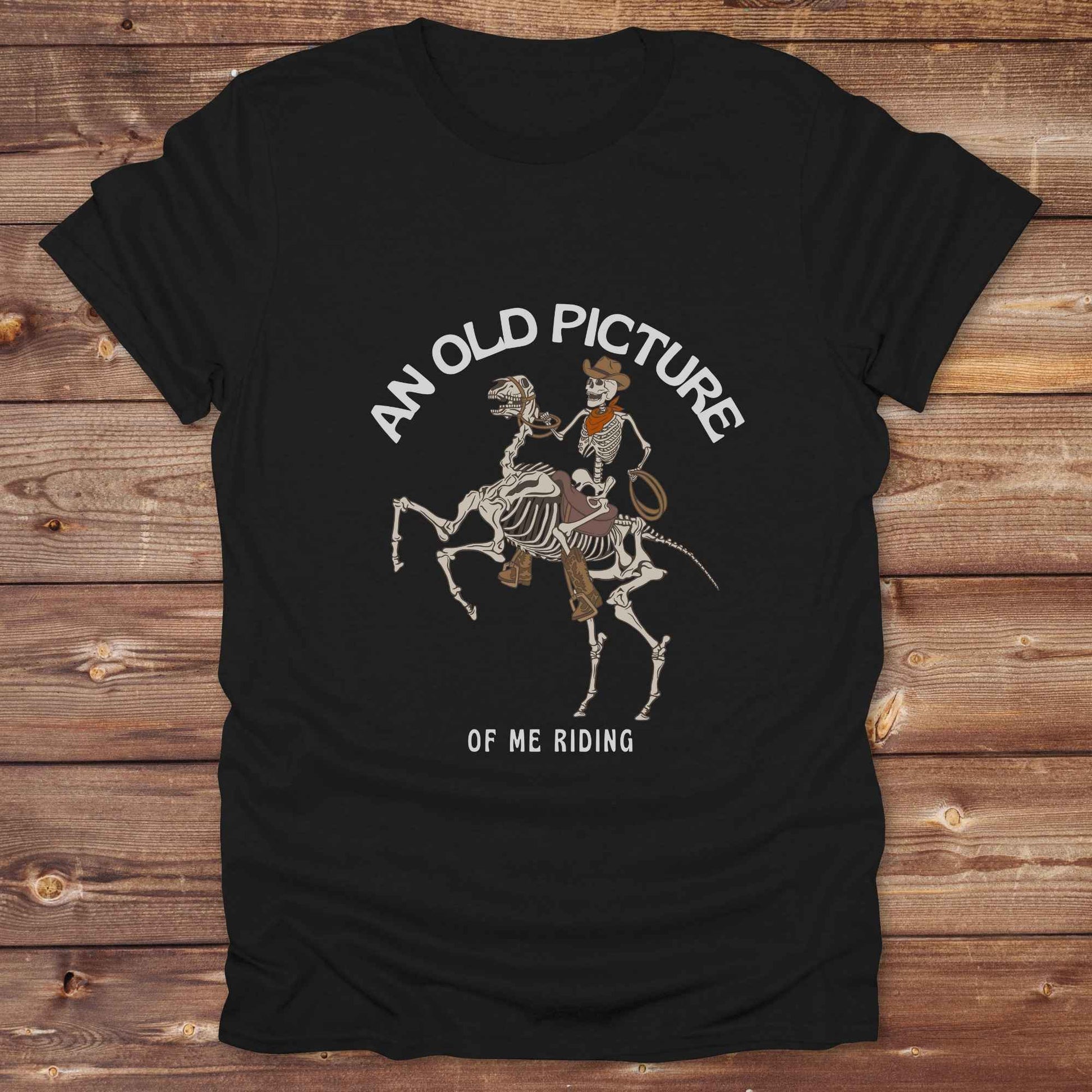 Saddle up with spooky western vibes in this skeleton cowboy “Old Picture of Me Riding” shirt, perfect for rodeo lovers and Halloween humor fans. This cowboy skeleton t-shirt combines retro western style with dark humor, ideal for ranchers, riders, and funny costume alternatives. Make fall fashion unforgettable with this witty, rustic western parody tee featuring bones, boots, and bold cowboy nostalgia.